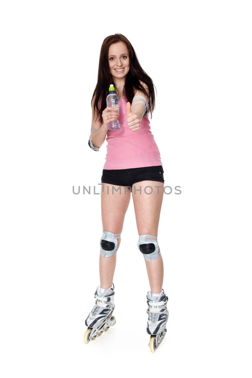 The beautiful young woman in rollerskates on a white background.