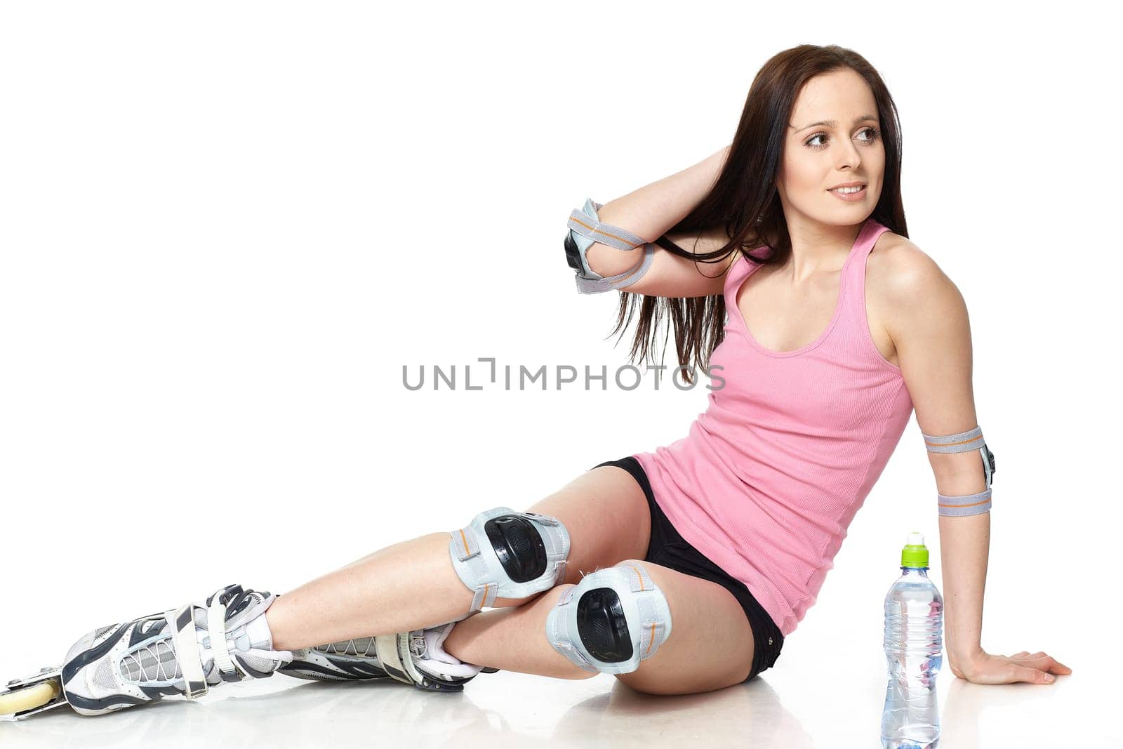 The beautiful young woman in rollerskates on a white background.