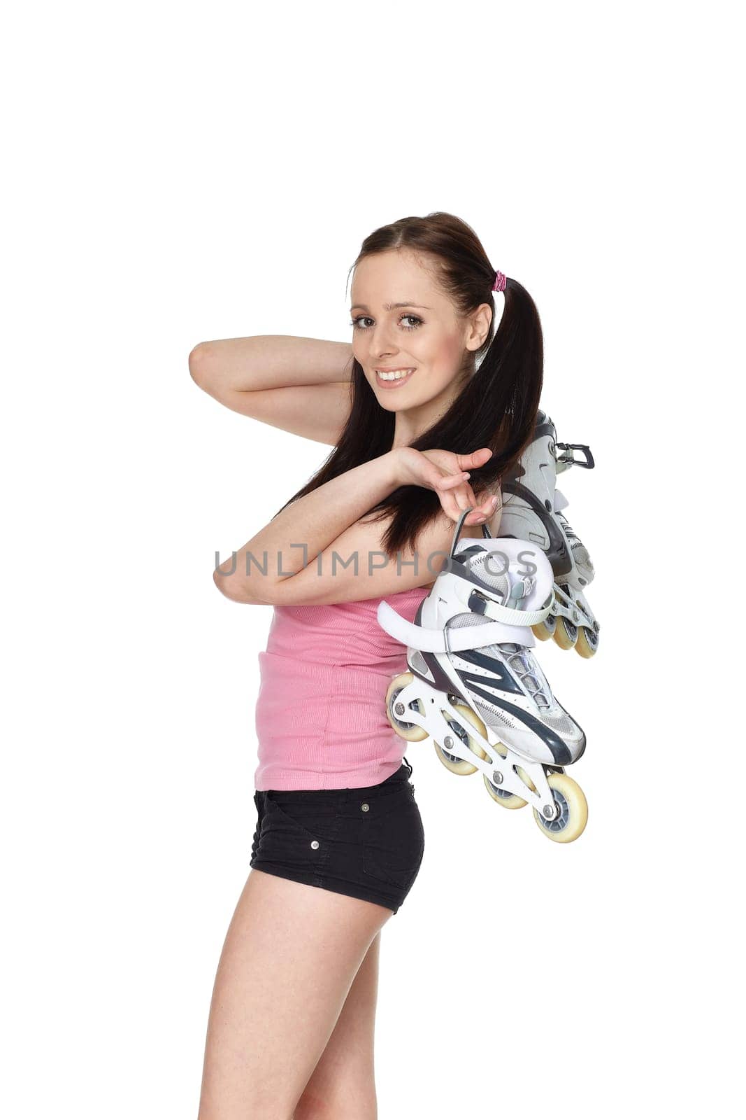 Young sporty woman with rollerskates on a white background.
