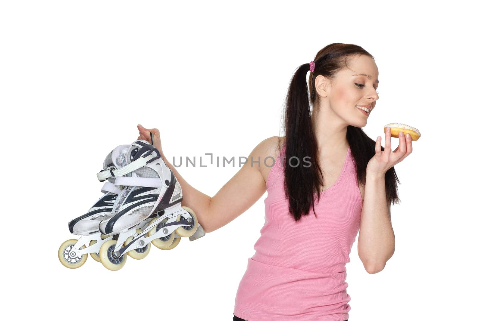 Young sporty woman with rollerskates and donut on a white background. Choice problem.