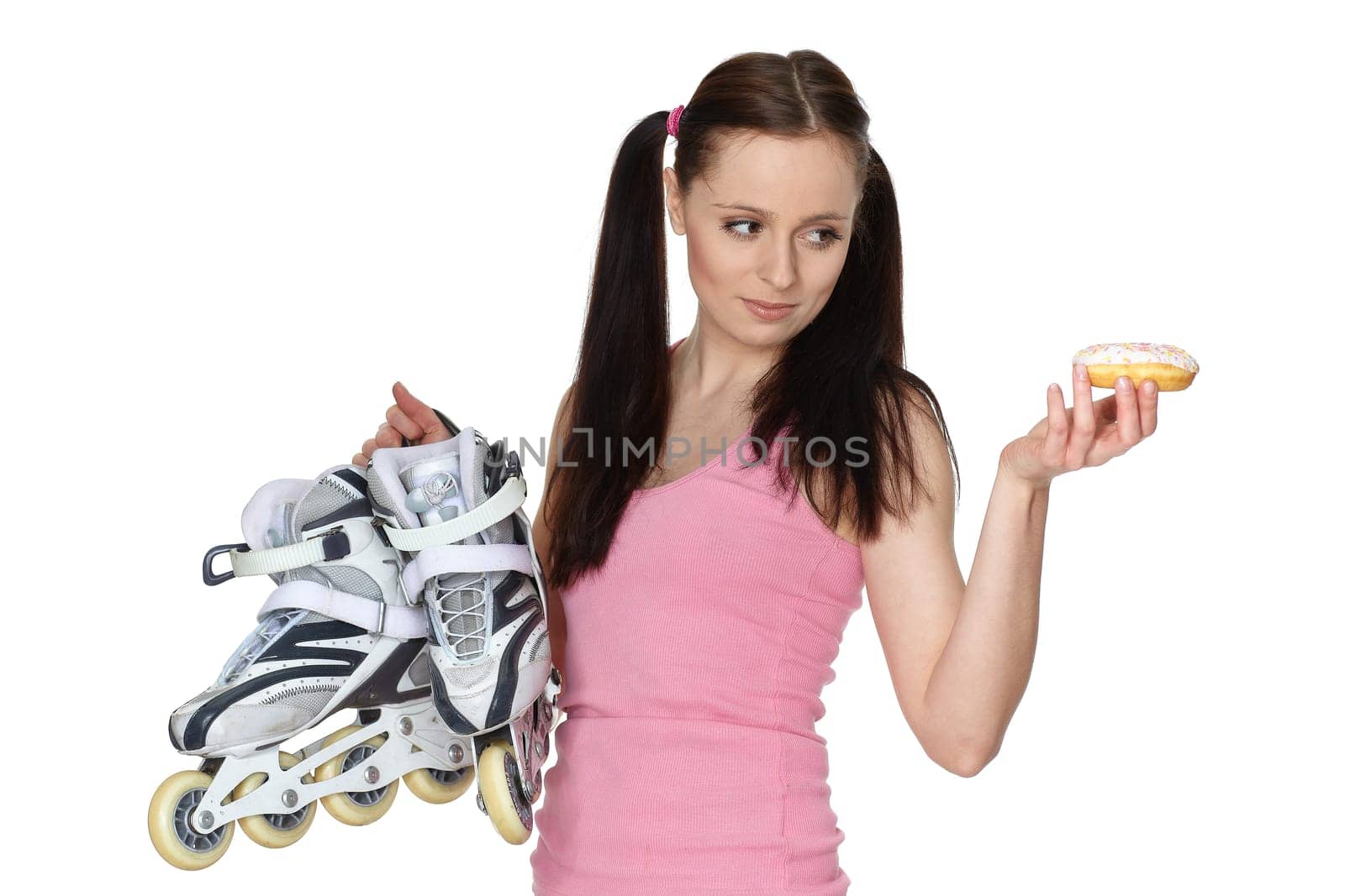 Young sporty woman with rollerskates and donut on a white background. Choice problem.