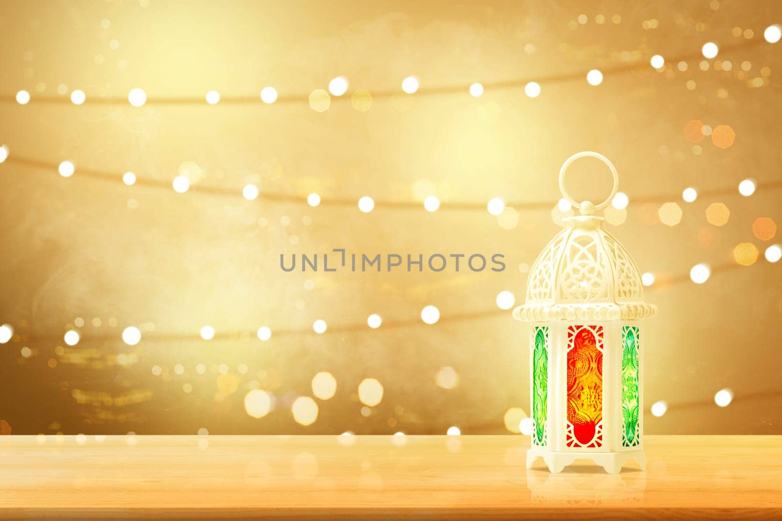 Arabic lamp with beautiful light on wooden table with blurry lights background