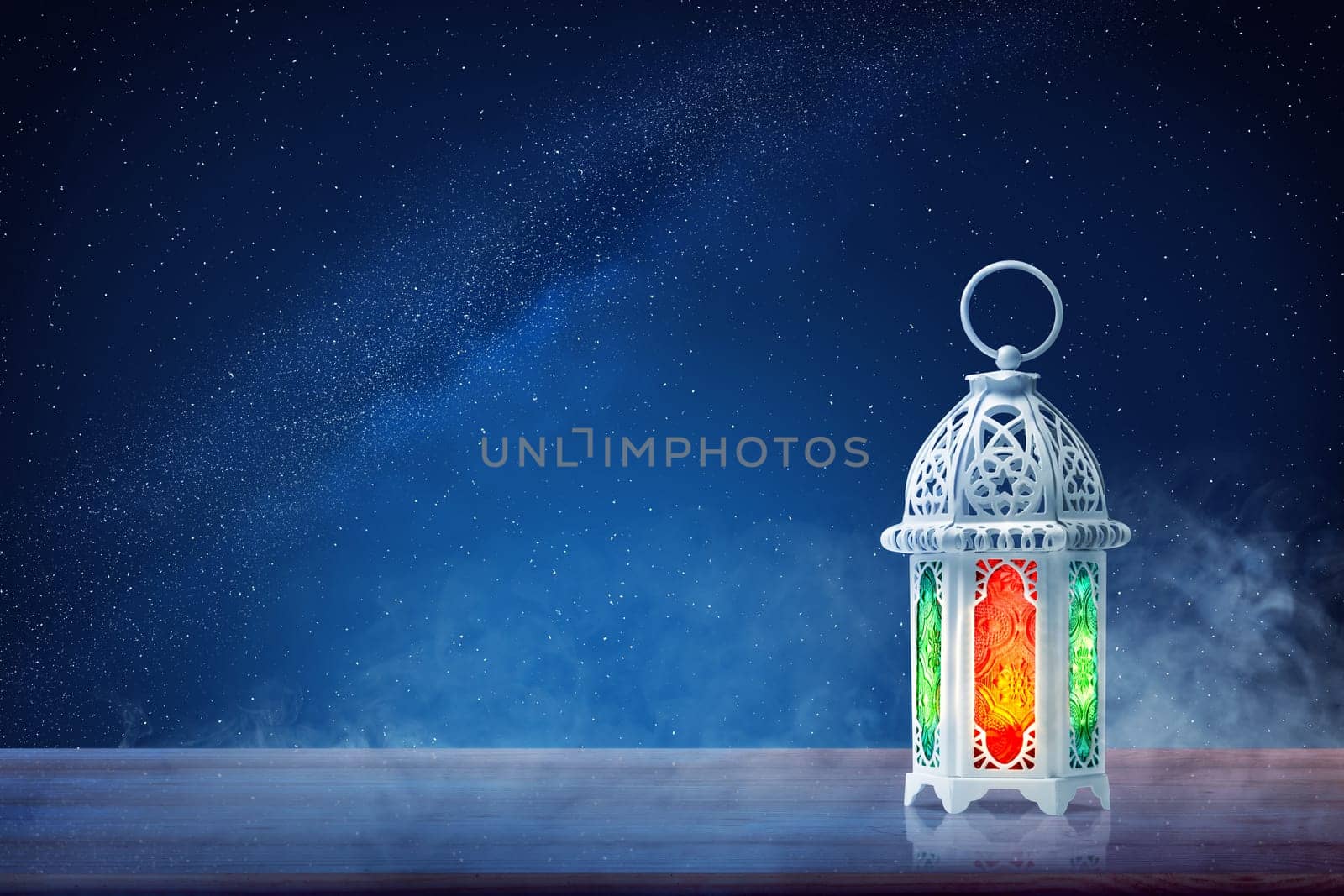 Arabic lamp with beautiful light on wooden table at outdoor with night scene background