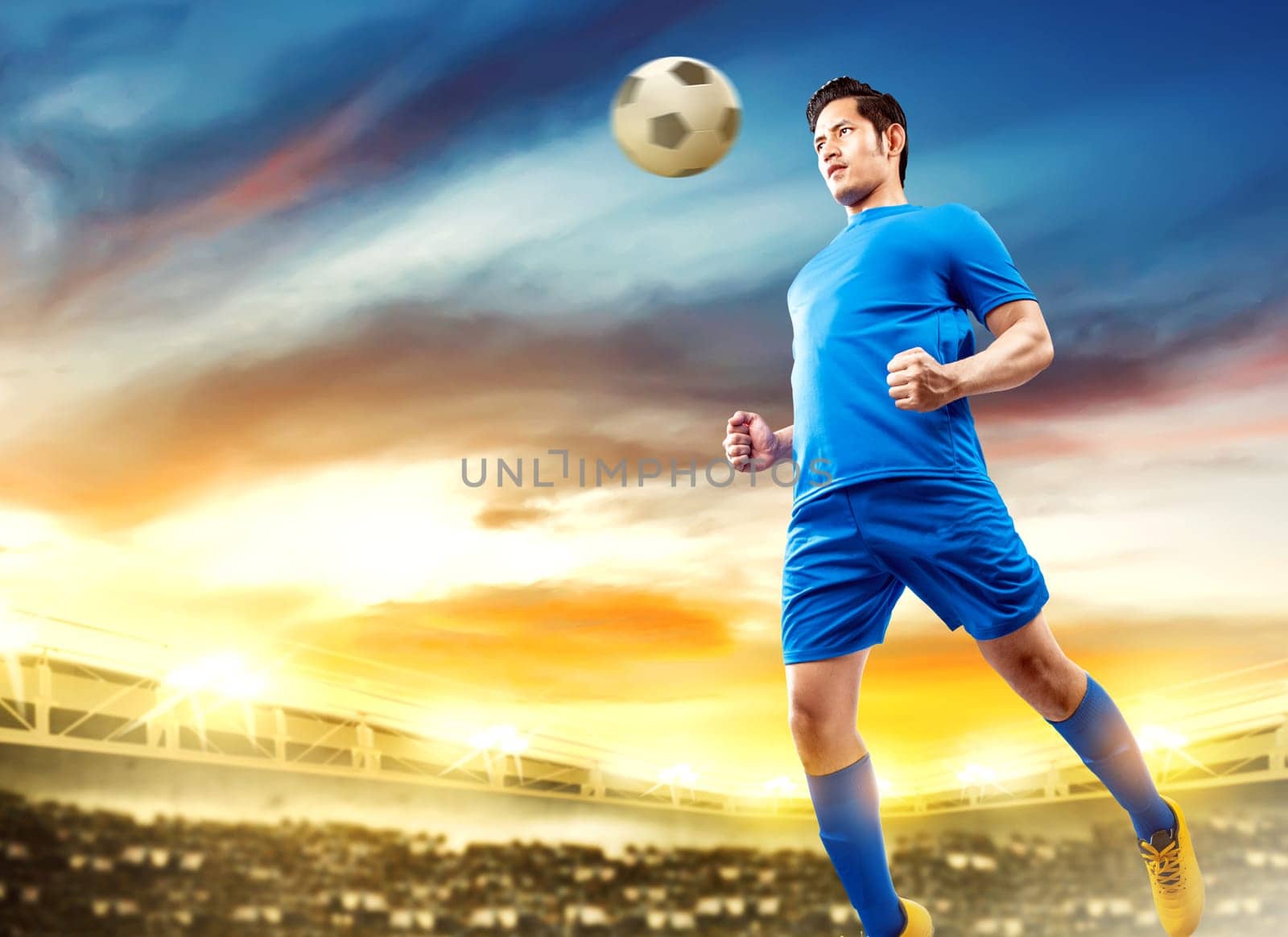 Asian football player man jump in the air and heading the ball on football field at stadium