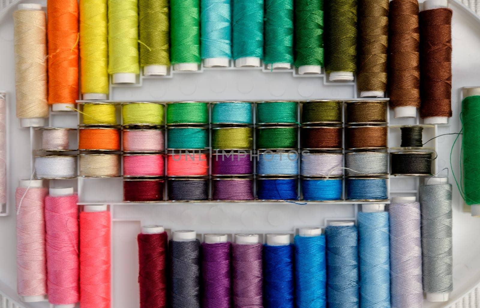 a lot of colorful yarn in organizer box