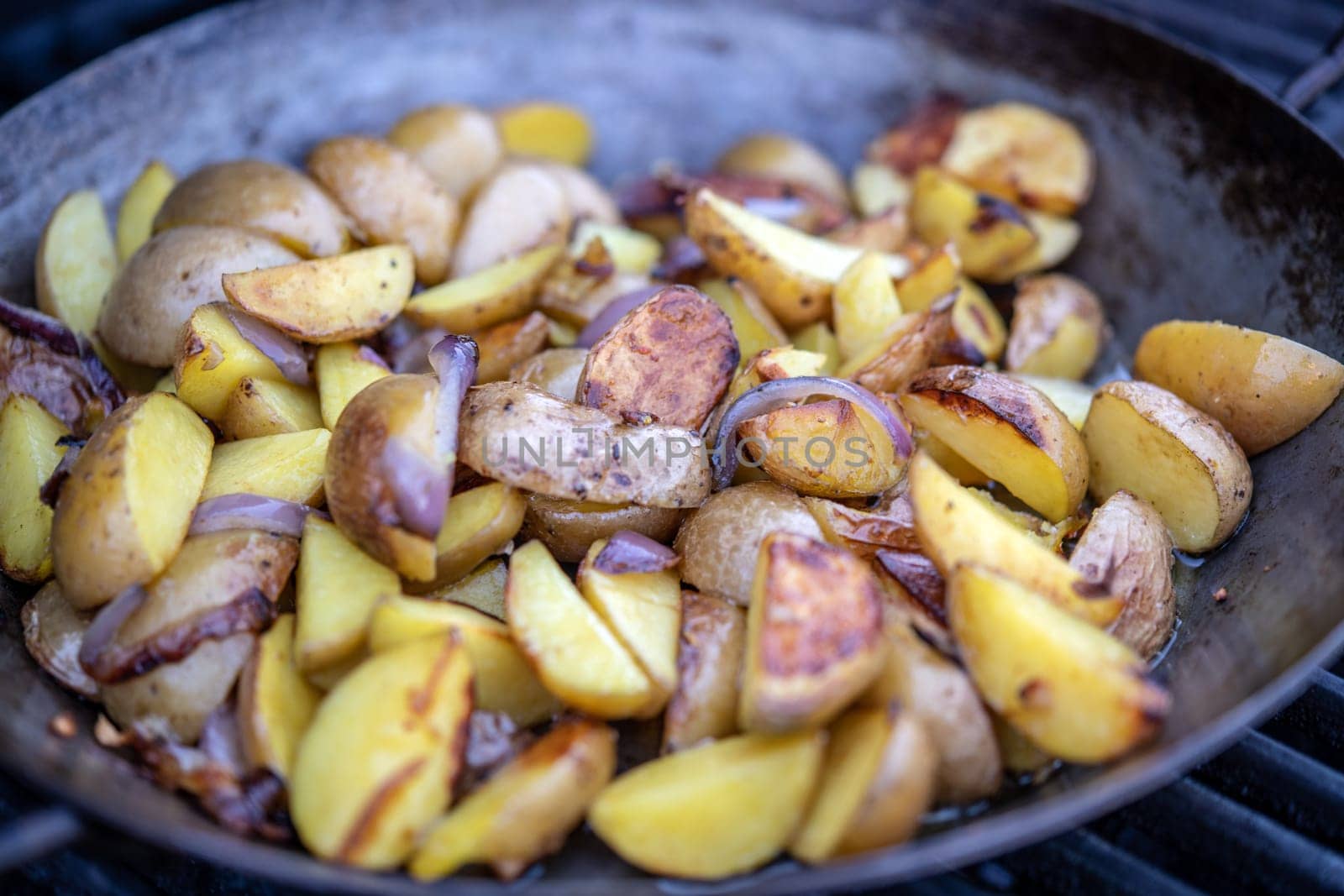 grilled potatos with onionin iron pan