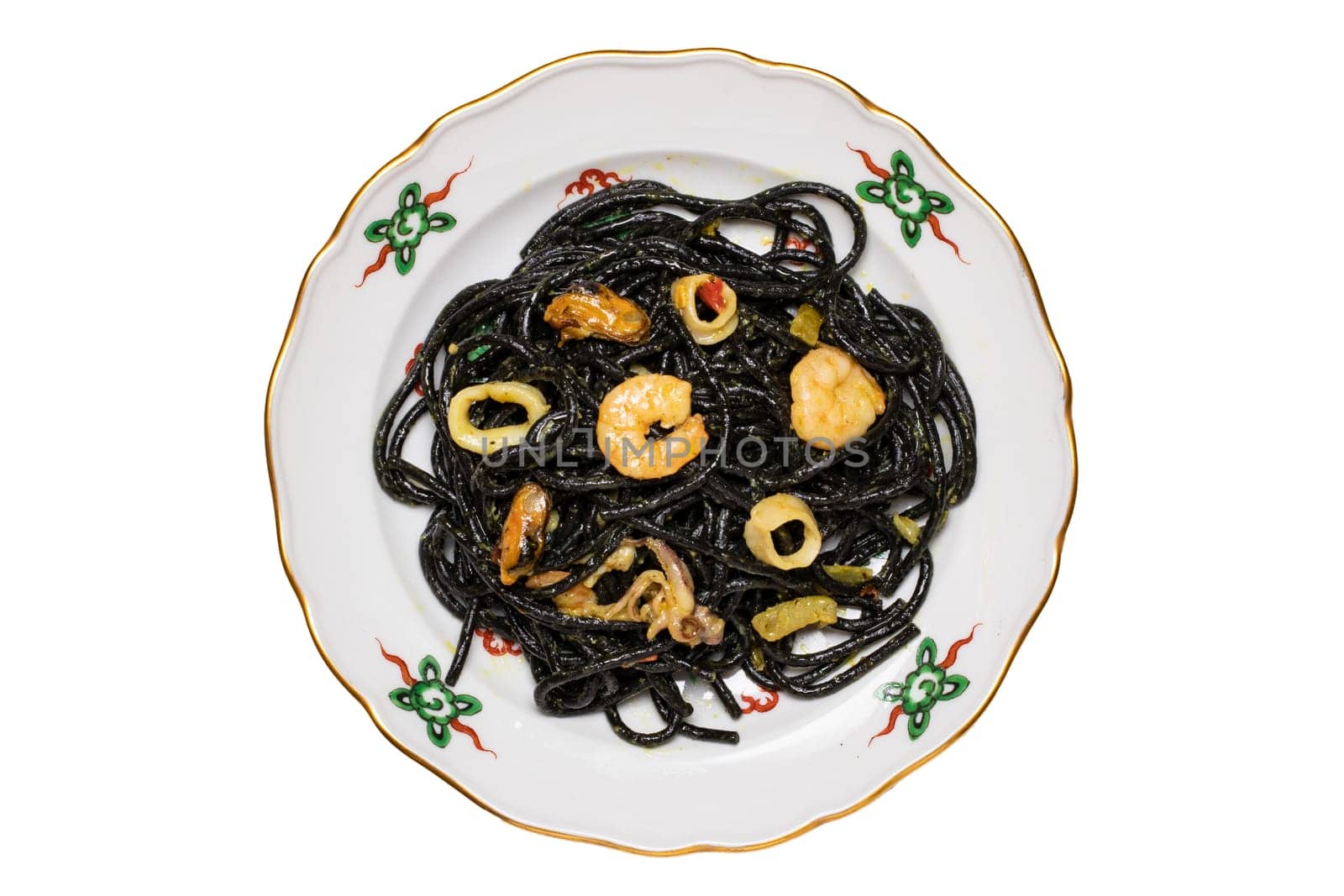 Top view of italian black pasta with seafood. Closeup of mediterranean black noodles with cuttlefish ink, mussels and shrimps isolated on a colorful plate. Macro.