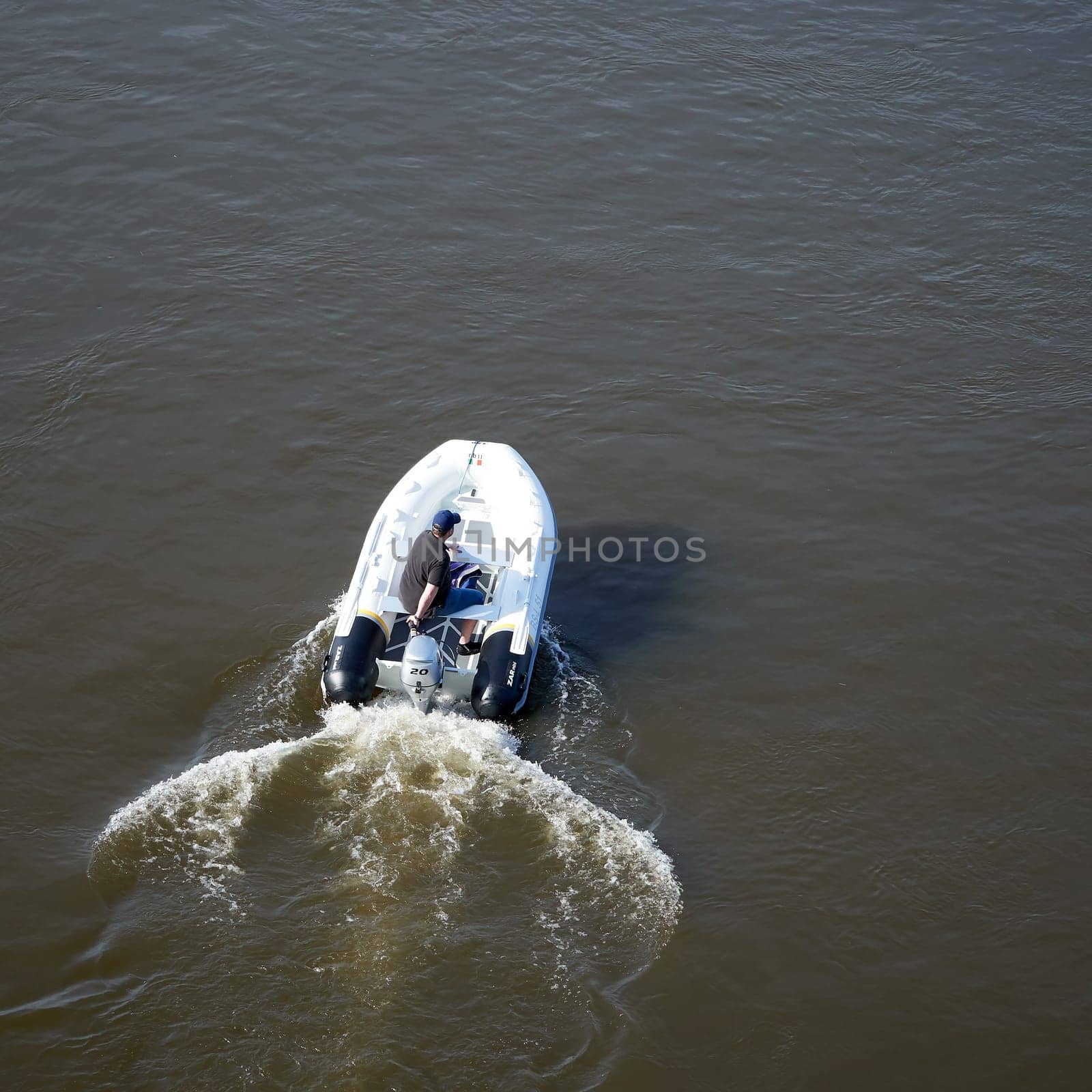 a motorboat driver photographed on the river Elbe near Magdeburg from a bridge