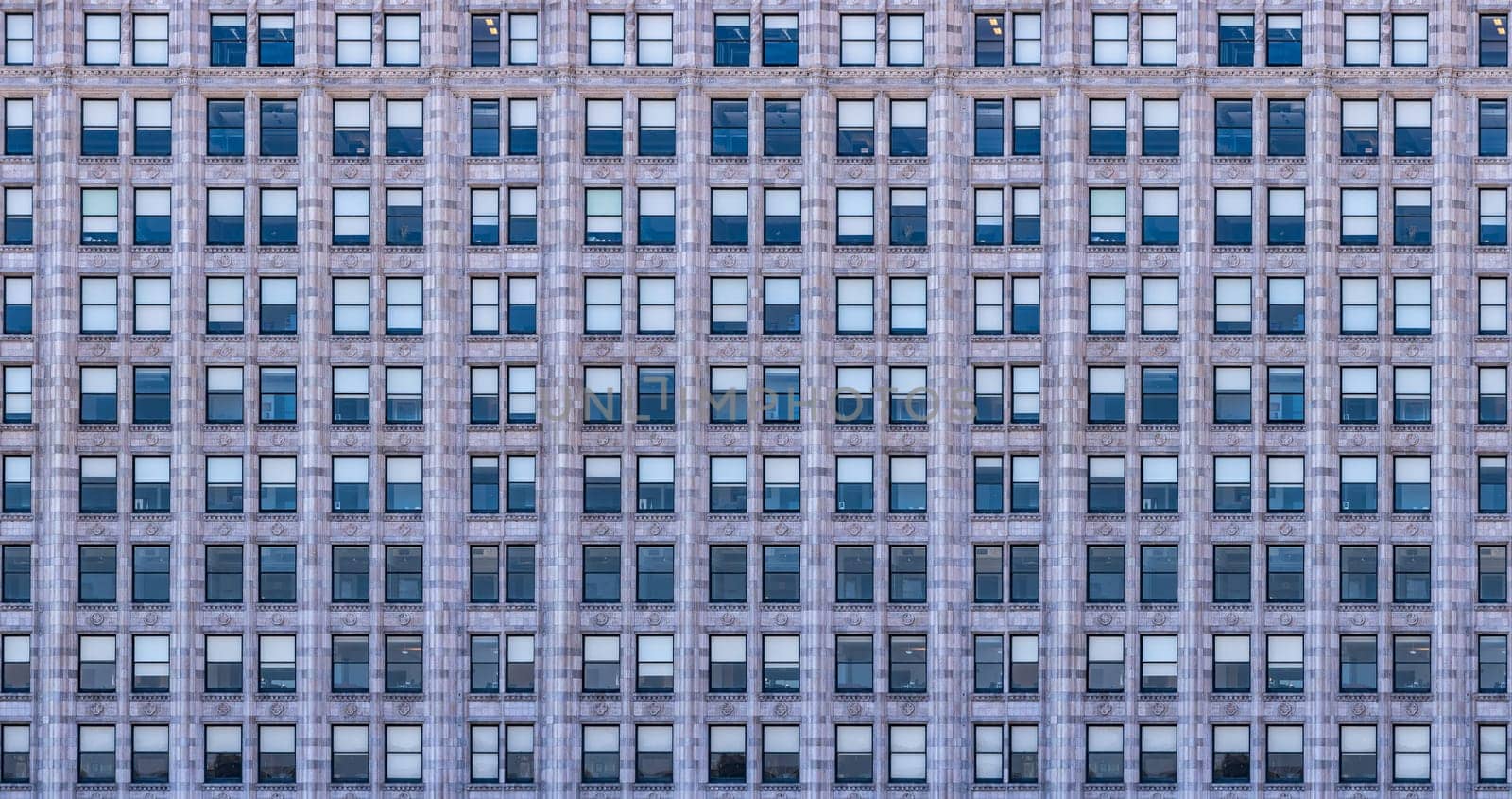 Urban abstract - window facade of business center office building with reflections and colours.