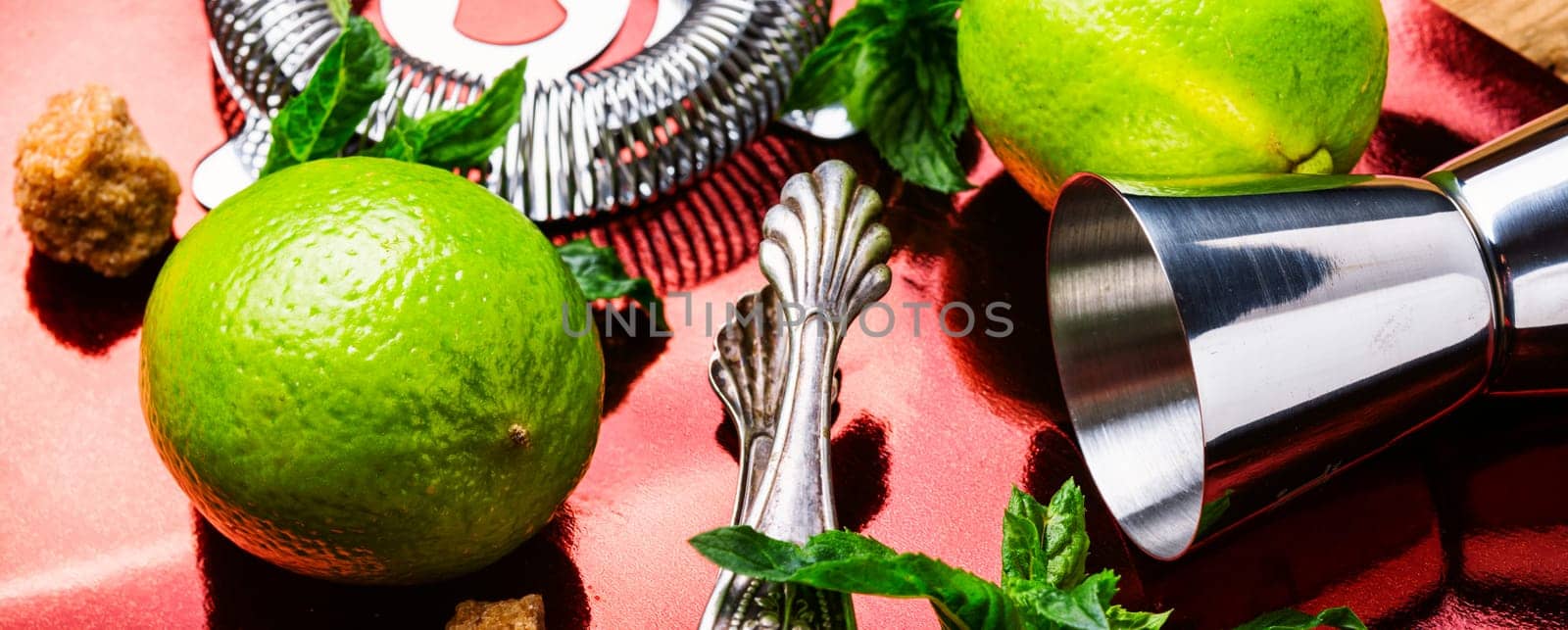 Fresh mojito cocktail and bar utensils.Mojito cocktail with mint and lime