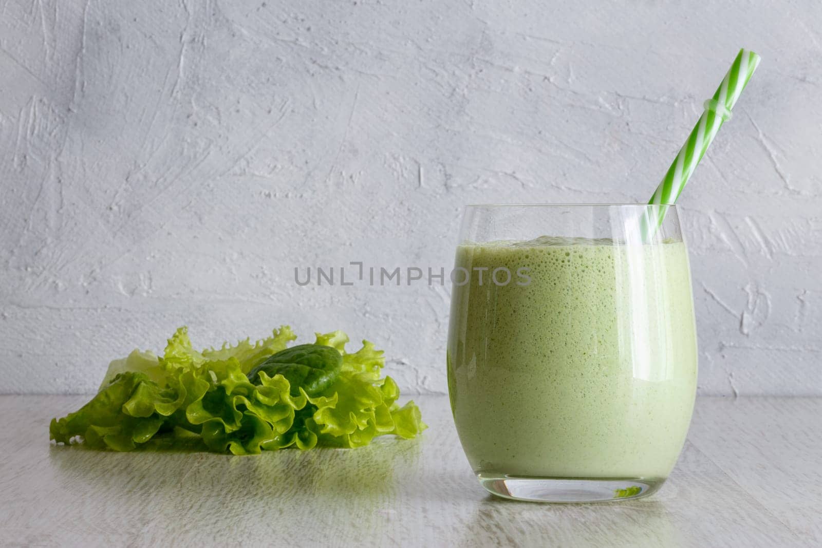 Smoothies from Greek yogurt with herbs on a gray background