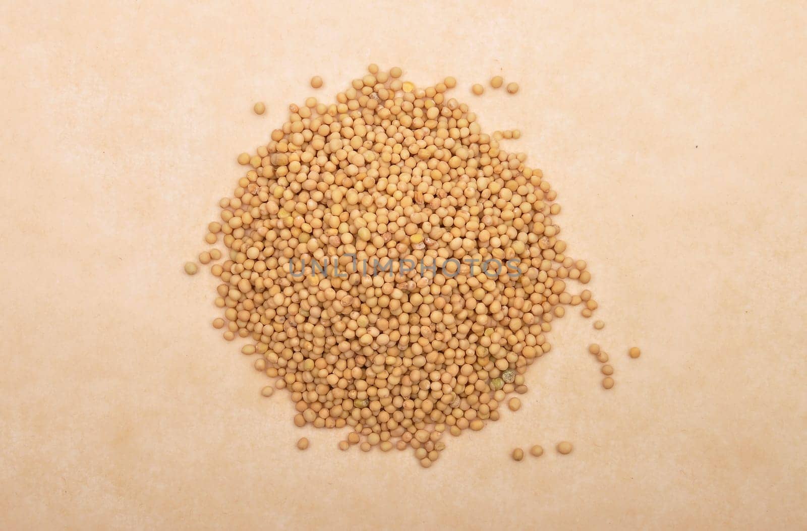 Mustard seeds on brown background