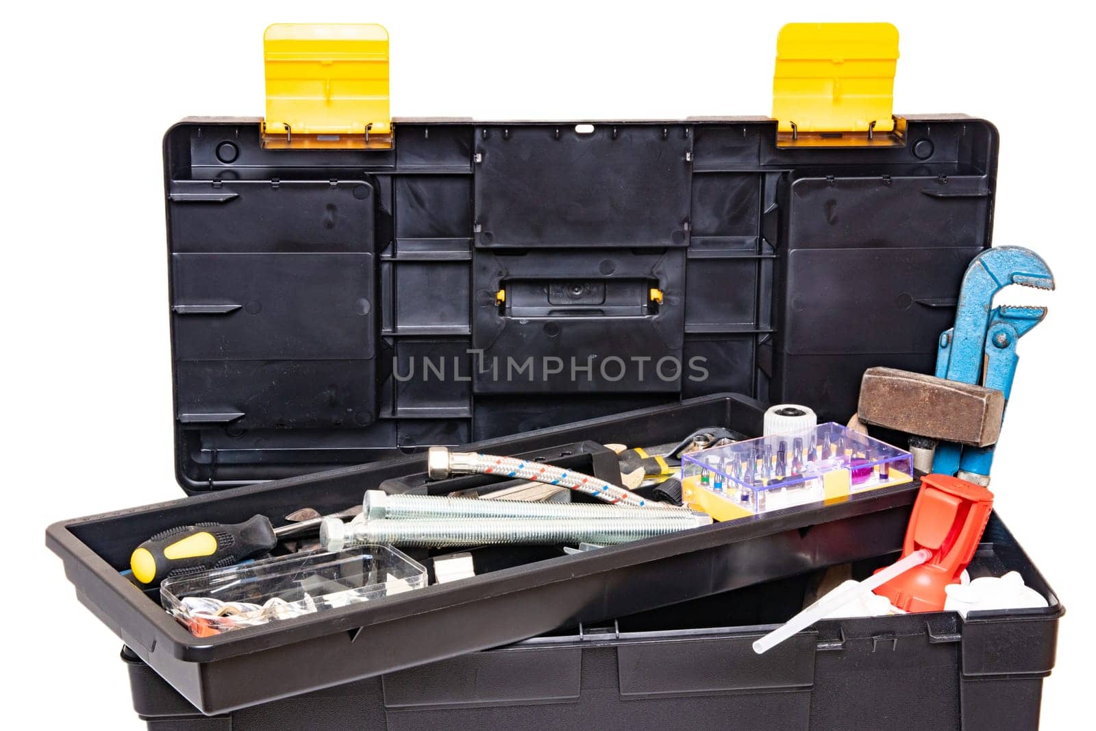 Tool box isolated. Black plastic tool kit box with assorted tools and with various nails, screws, fasteners as well as dowels isolated on a white background.