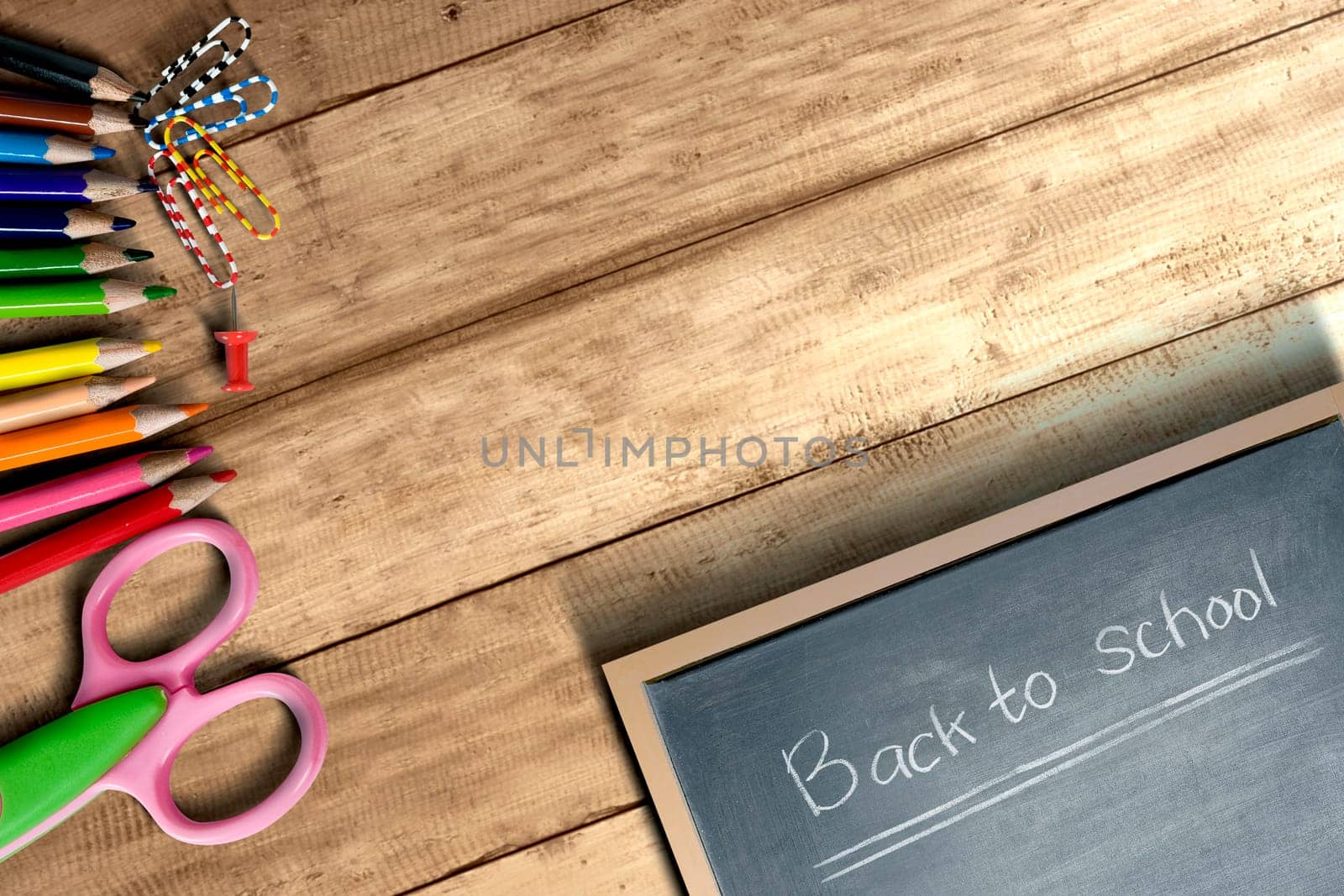 School supplies and stationery with little blackboard with Back to School text on wooden table. Back to School concept