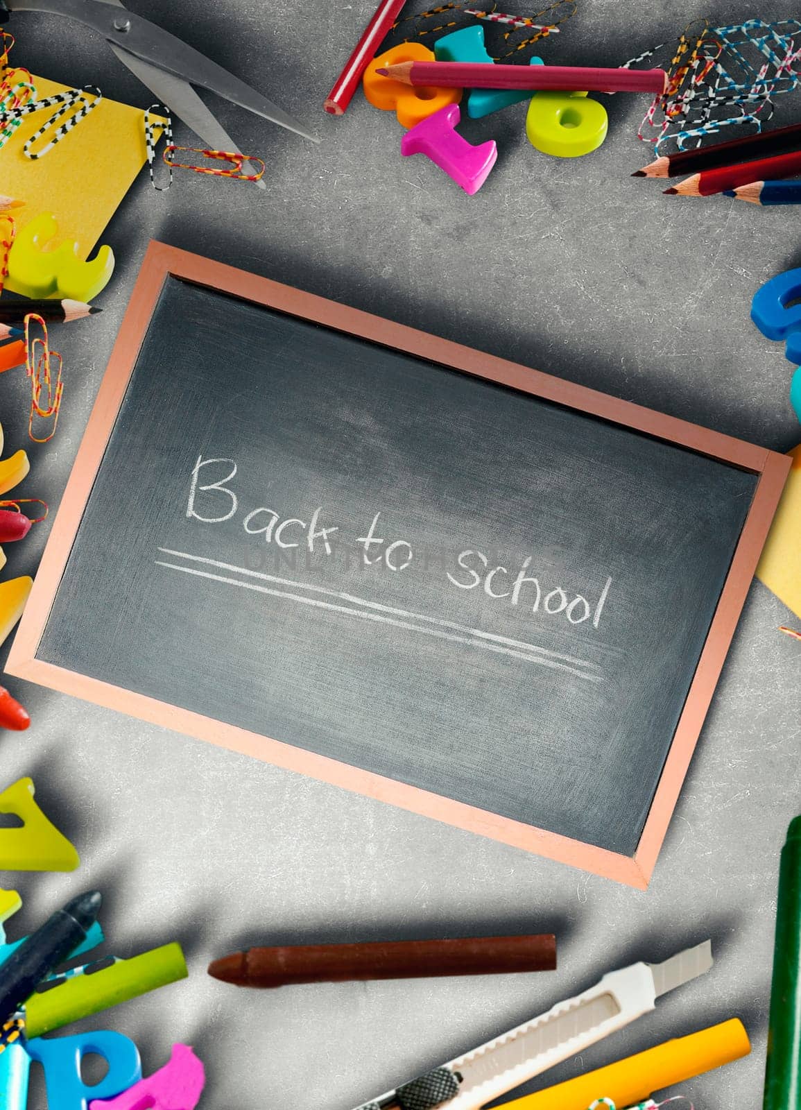 School supplies and stationery on blackboard and little chalkboard with Back to School text. Back to School concept