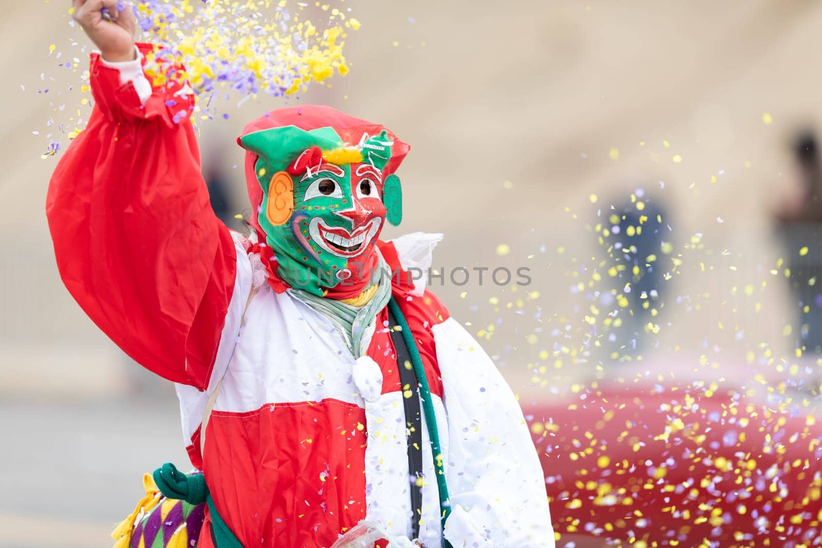St. Louis, Missouri, USA - March 2, 2019: Bud Light Grand Parade, Person in a jester costume throwing confetti into the air during the parade
