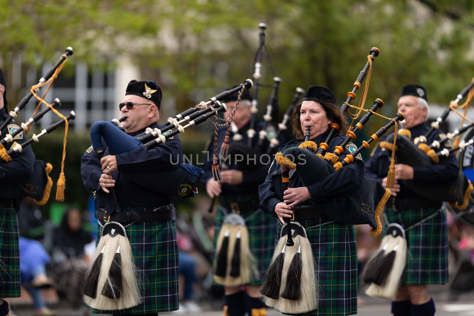Wilmington, North Carolina, USA - April 6, 2019: The North Carolina.Azalea Festival, Members of the Wilmington's Police Force marching playing bagPipes during the parade