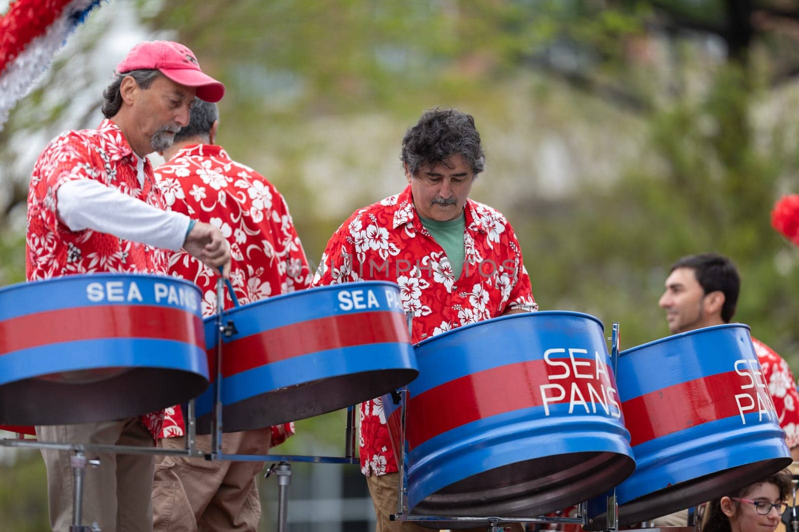 Wilmington, North Carolina, USA - April 6, 2019: The North Carolina.Azalea Festival,  Members of the Sea Pans playing steel drums during the parade