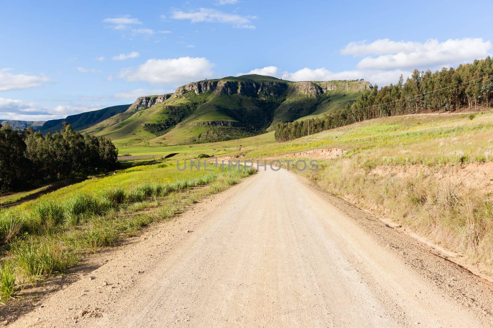 Rural dirt road route along scenic summer mountain landscape