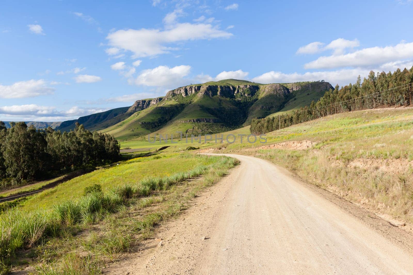 Rural dirt road route along scenic summer mountain landscape