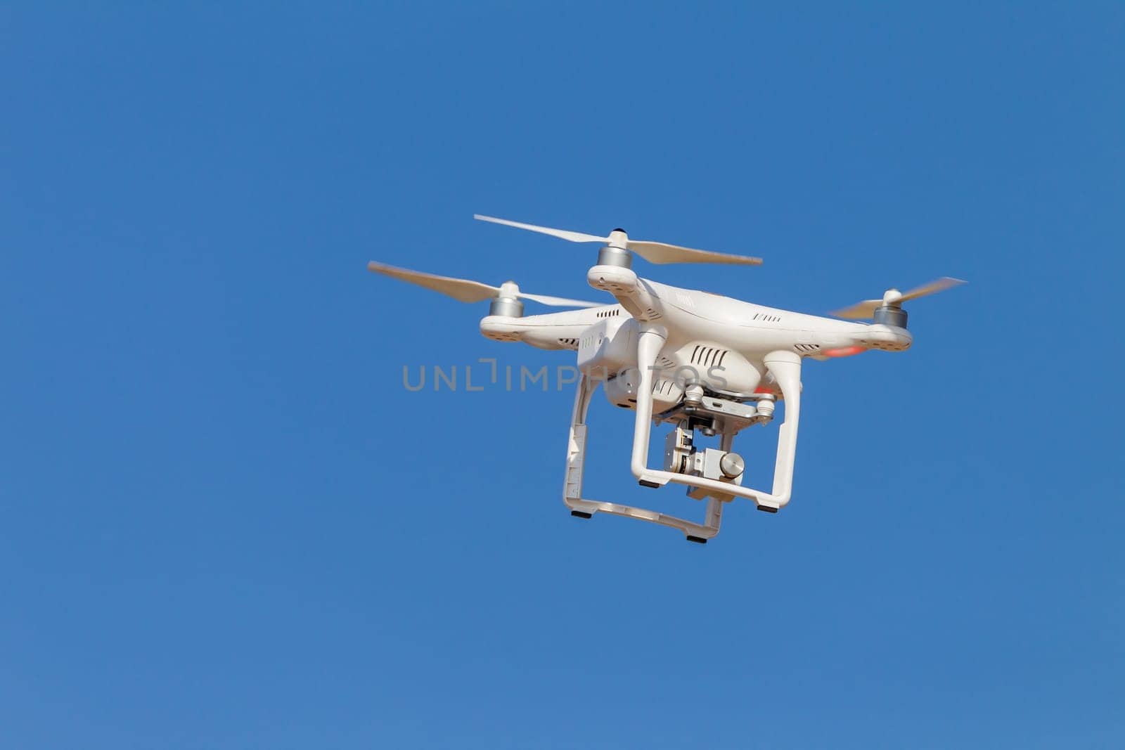 Drone aircraft remote video camera in blue sky closeup.