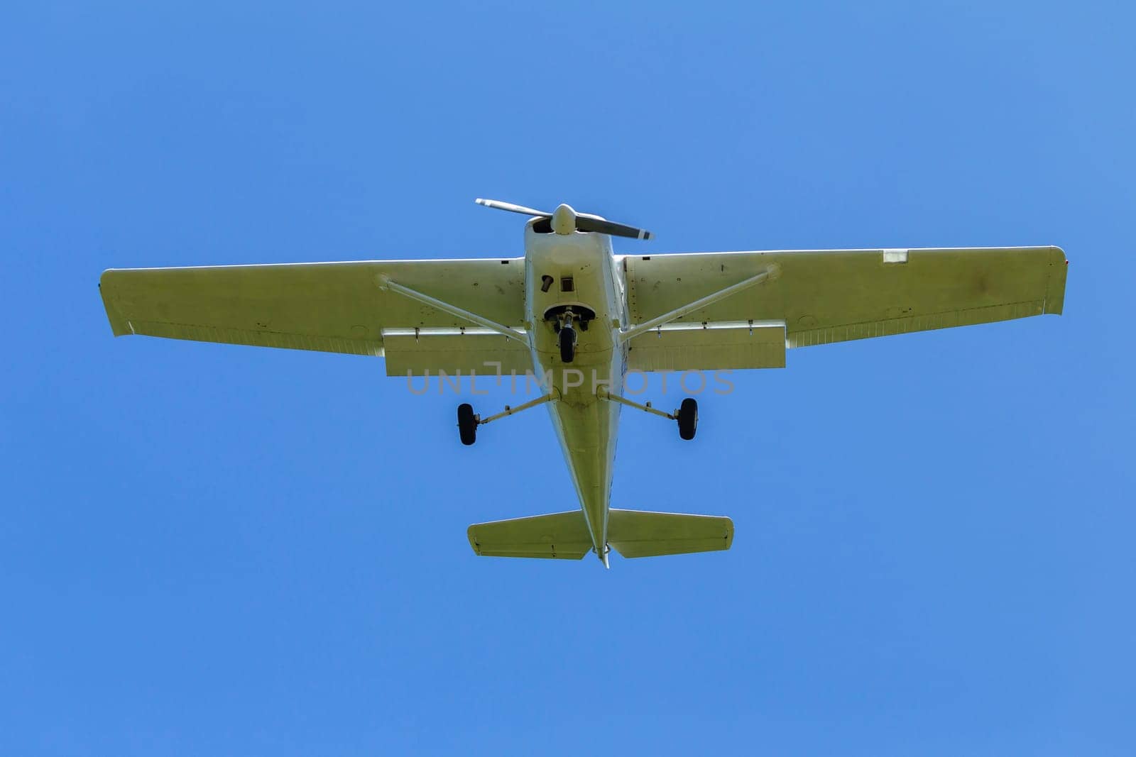 Plane light aircraft single prop flying overhead landing approach.