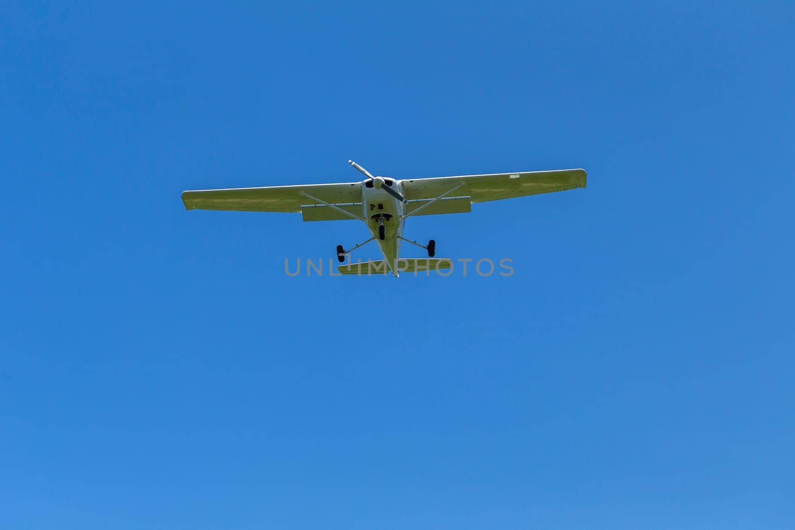 Plane light aircraft single prop flying overhead landing approach.