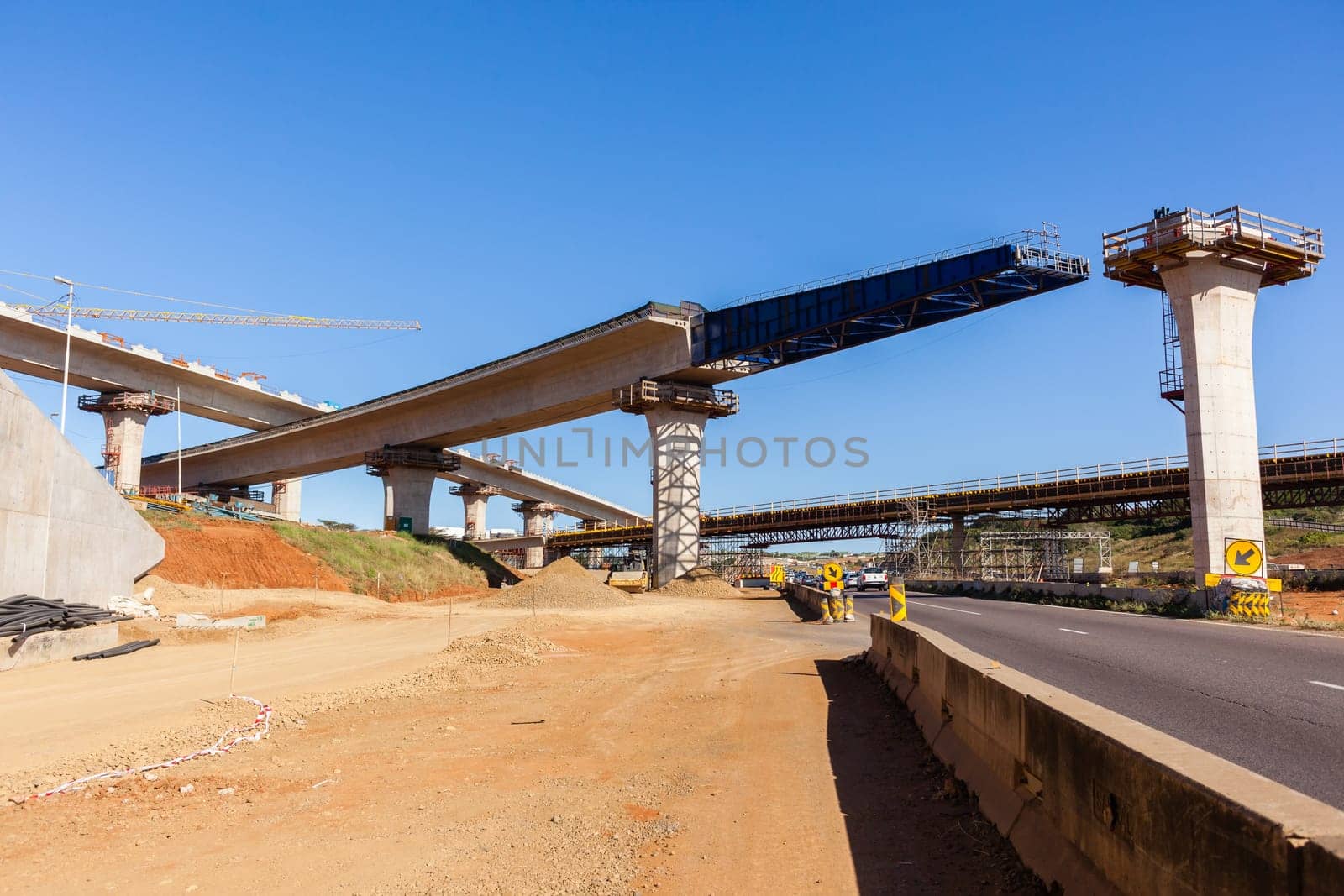 New Road highway expansion construction industrial building of overhead ramps concrete columns to traffic vehicle junction.