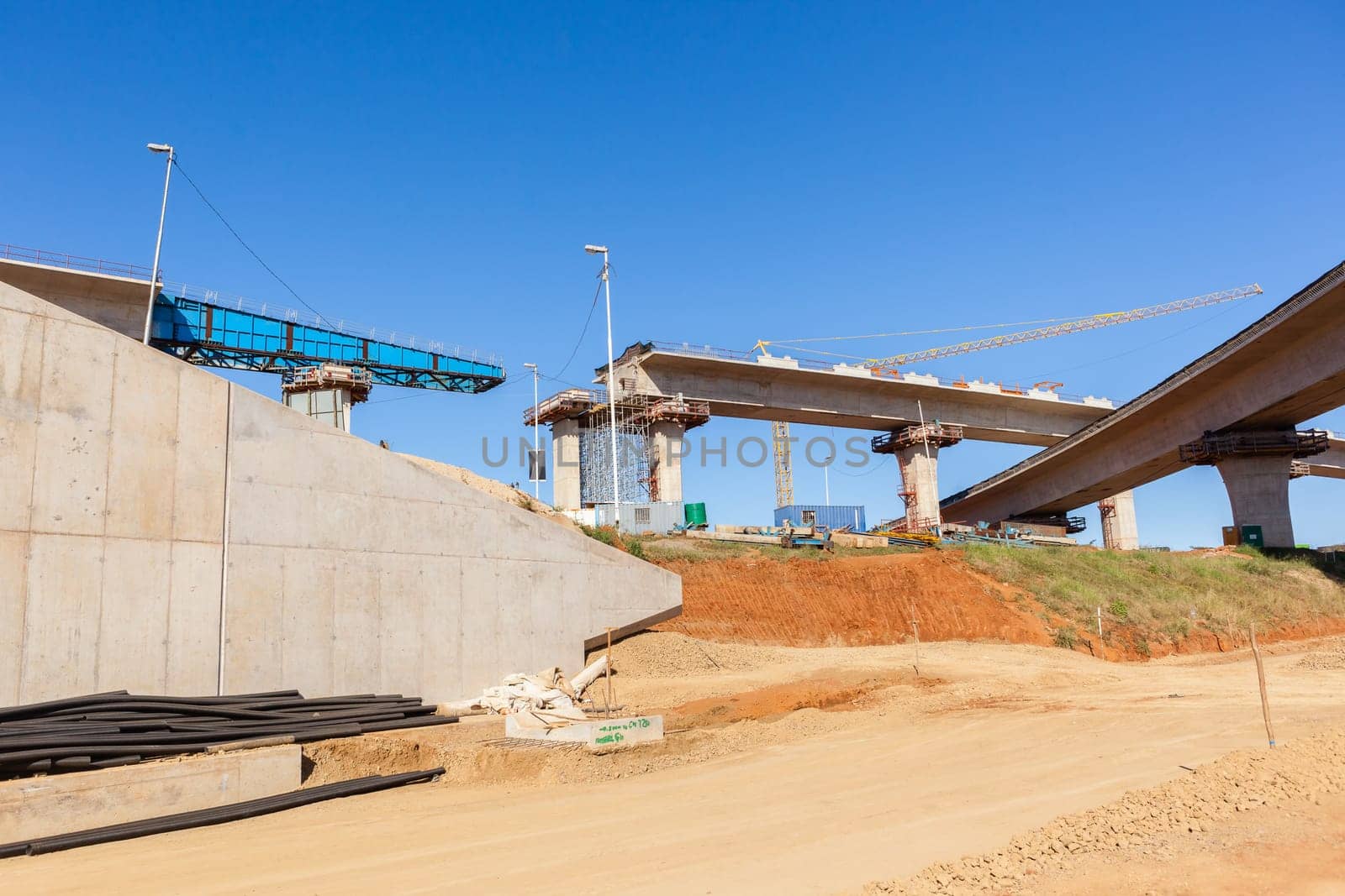 New Road highway expansion construction industrial building of overhead ramps concrete columns to traffic vehicle junction.