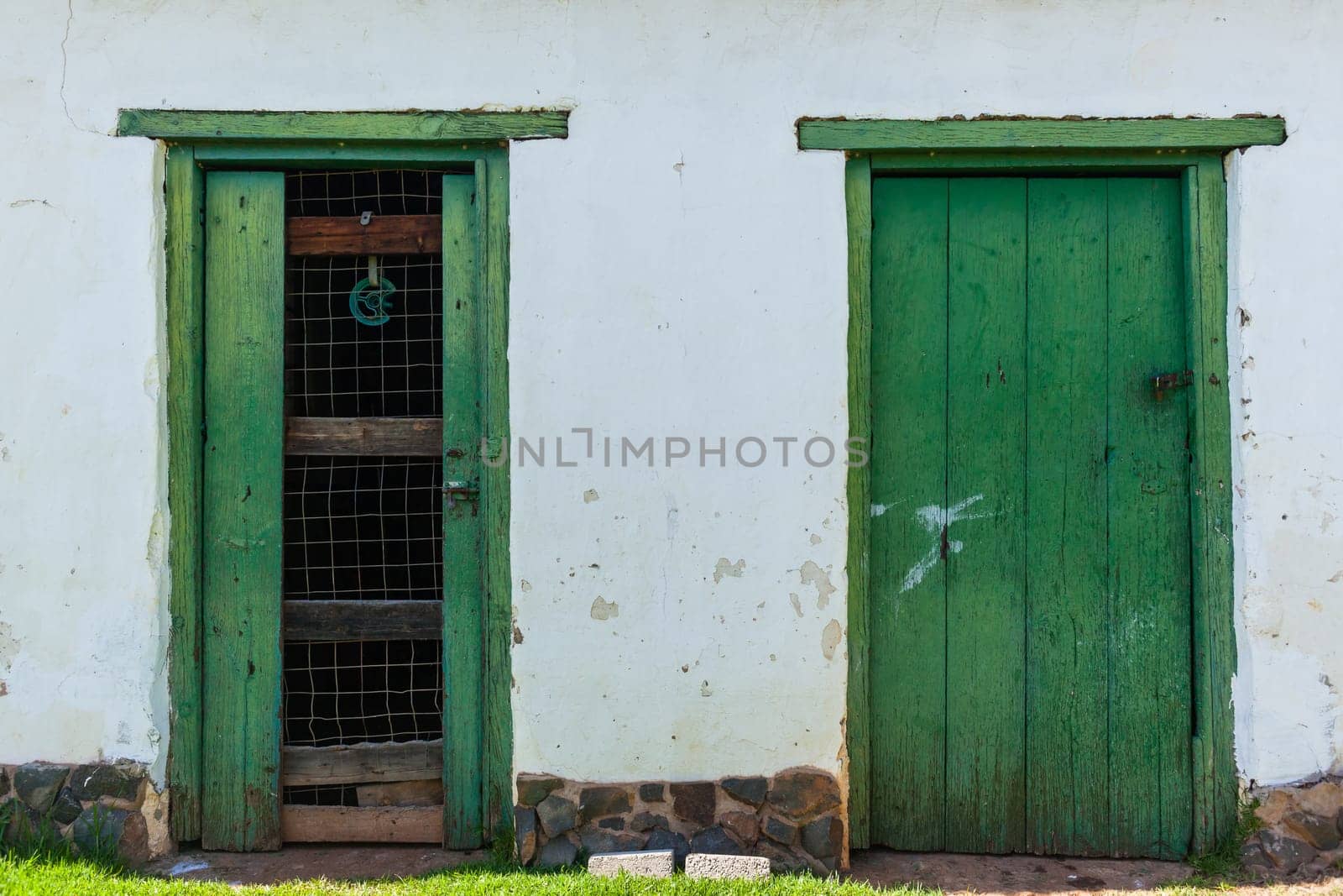 Vintage door wood frames in farm wall outside storeroom structure