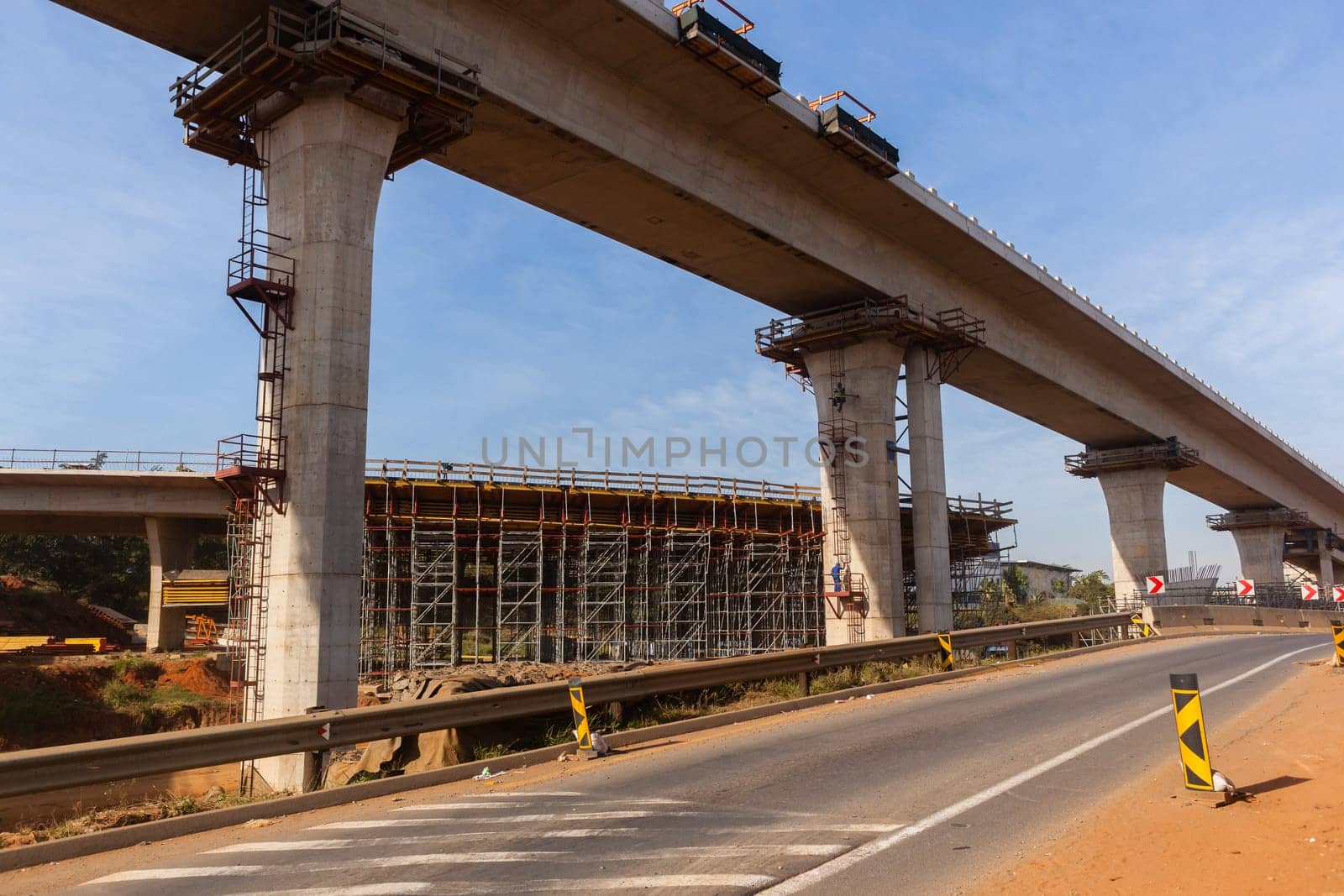 New Road highway expansion construction industrial building of overhead ramps concrete columns to traffic vehicle junction.