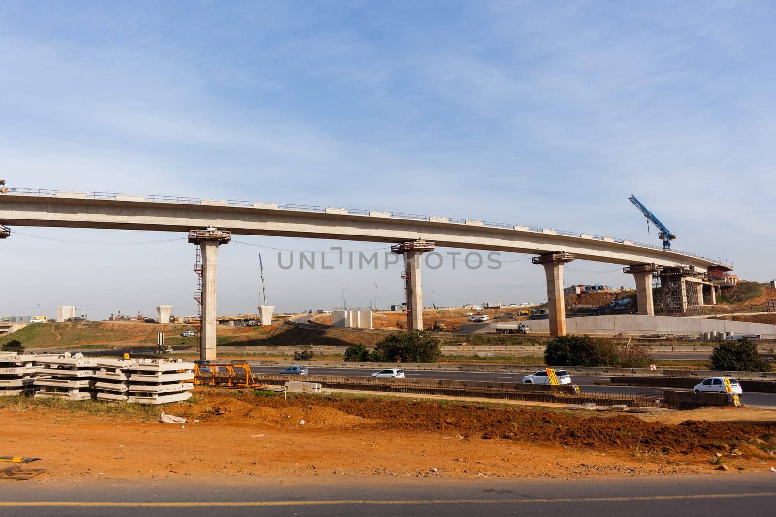 New Road highway expansion construction industrial building of overhead ramps concrete columns to traffic vehicle junction.