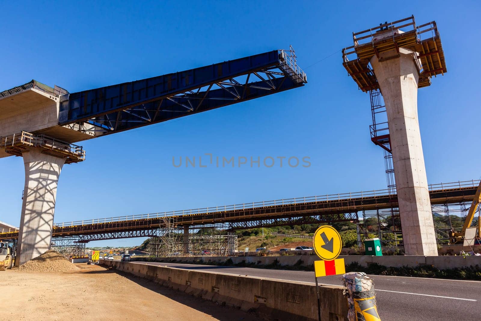 New Road highway expansion construction industrial building of overhead ramps concrete columns to traffic vehicle junction.