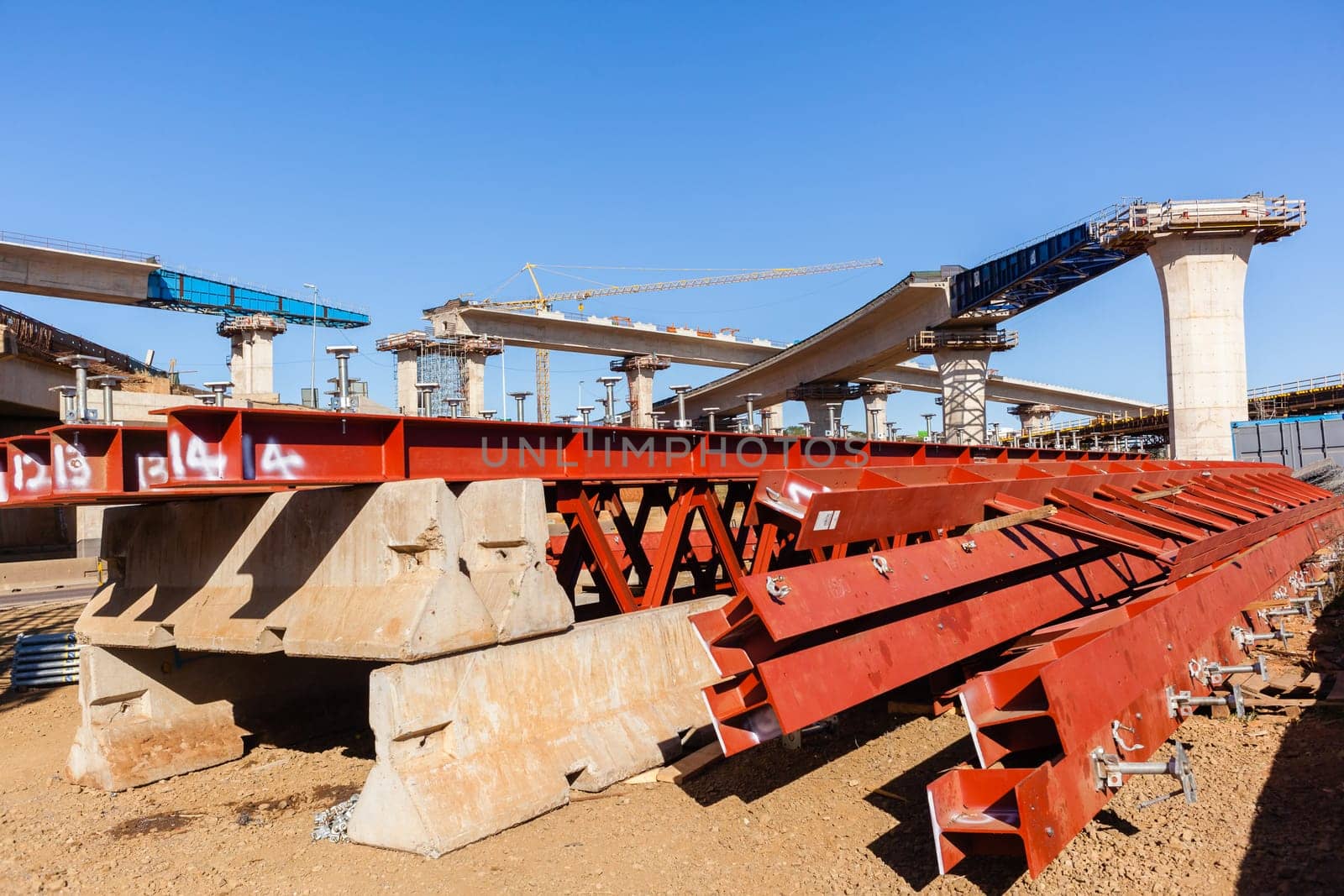 New Road highway expansion construction industrial building of overhead ramps concrete columns to traffic vehicle junction.