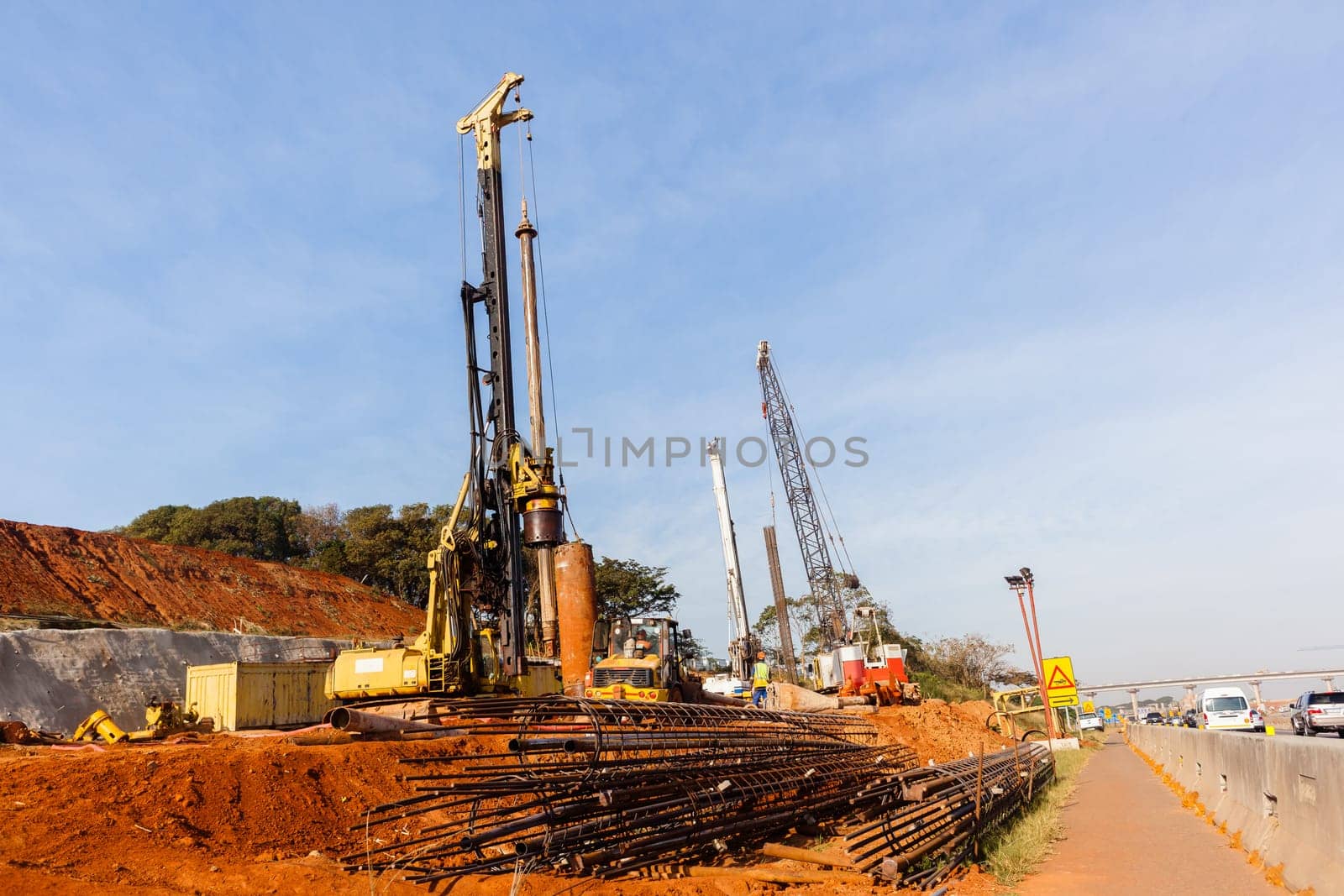 New Road highway expansion construction industrial building of overhead ramps concrete columns to traffic vehicle junction.