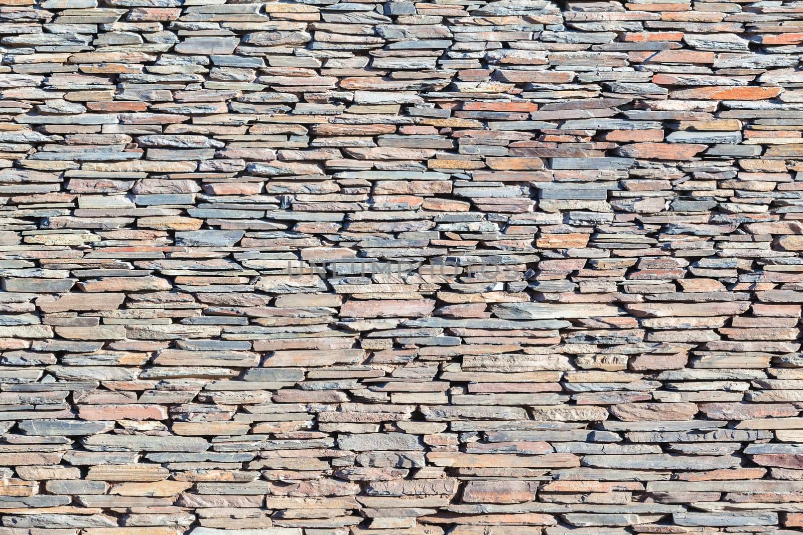 Slate stone wall closeup  photo of material texture background detail.