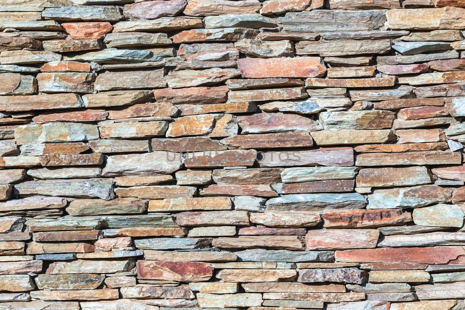 Slate stone wall closeup  photo of material texture background detail.