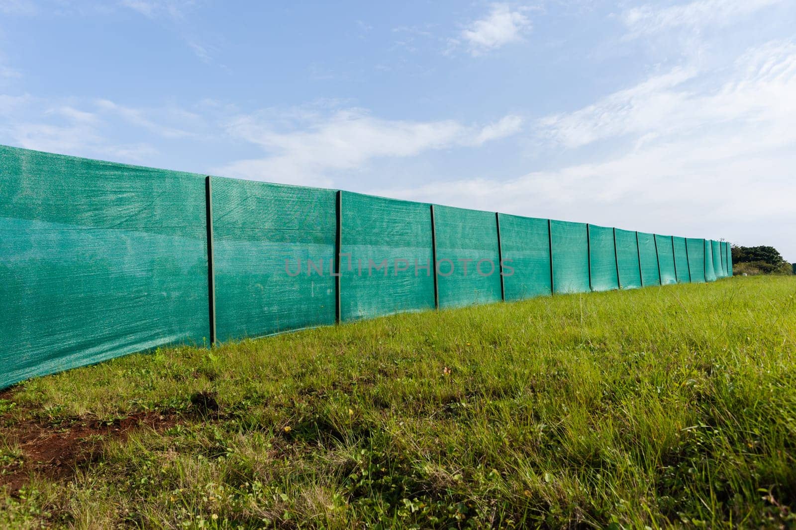 Construction building site boundary green nylon blinds.