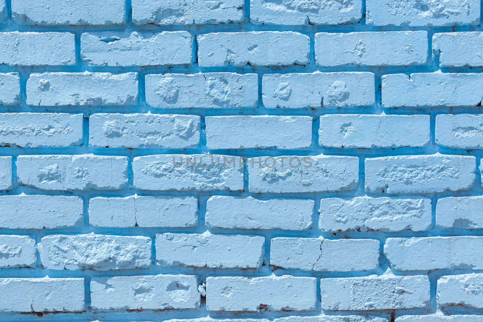 Brick wall painted blue outside decor texture detail color closeup background building structure..