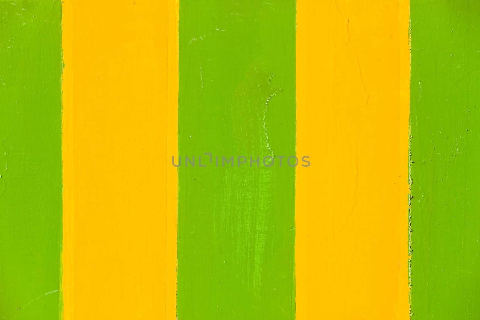 Paint stripes green yellow wet textures closeup background sign board panel.