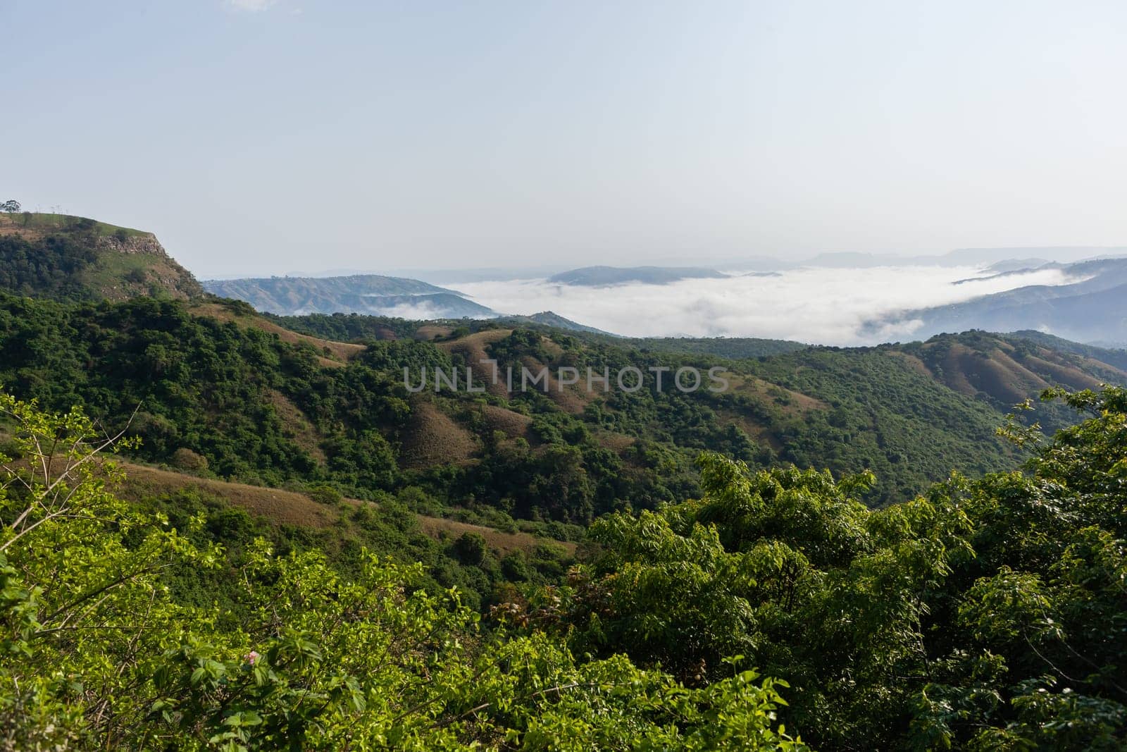 Overlooking rural valley with summer cloud mist over the tribal homes landscape.