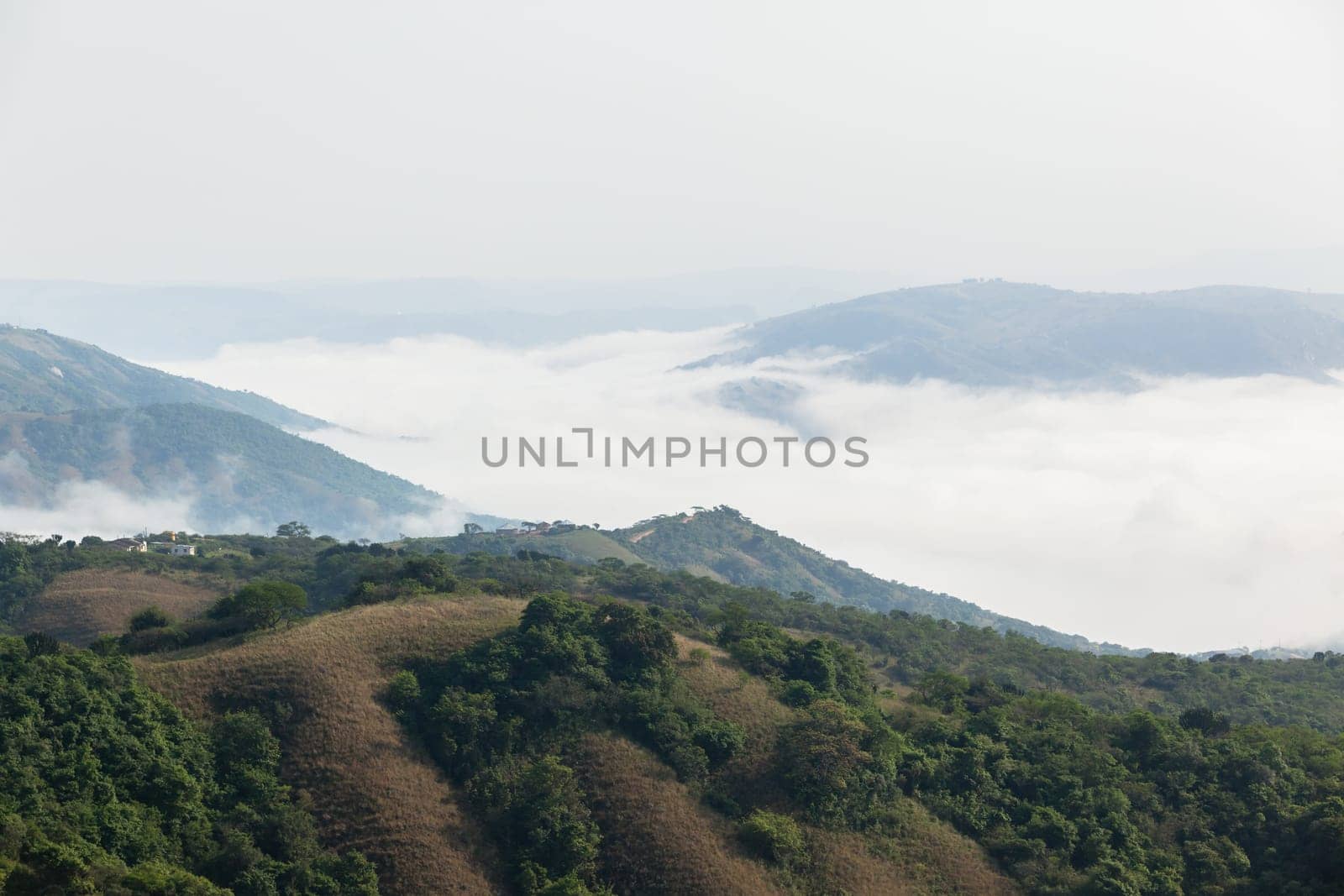 Overlooking rural valley with summer cloud mist over the tribal homes landscape.