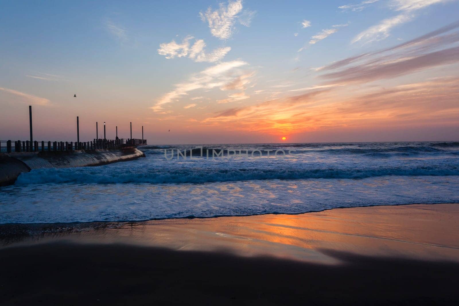 Beach ocean waves shoreline sunrise water sand color reflections horizon  skyline landscape
