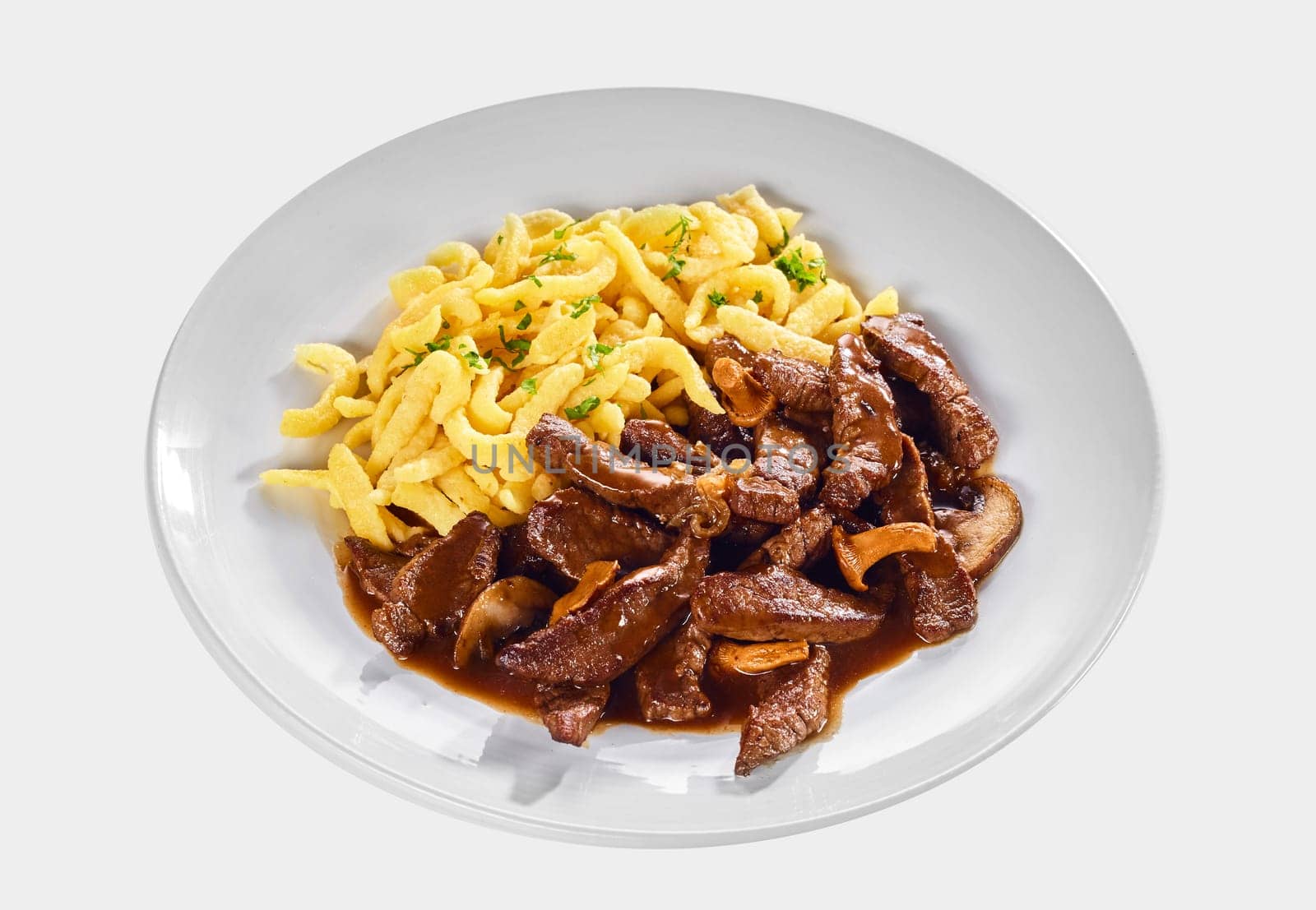 Strips of tender meat in a Swiss ragout with mushrooms and rich gravy sauce served with noodles isolated on white for menu advertising