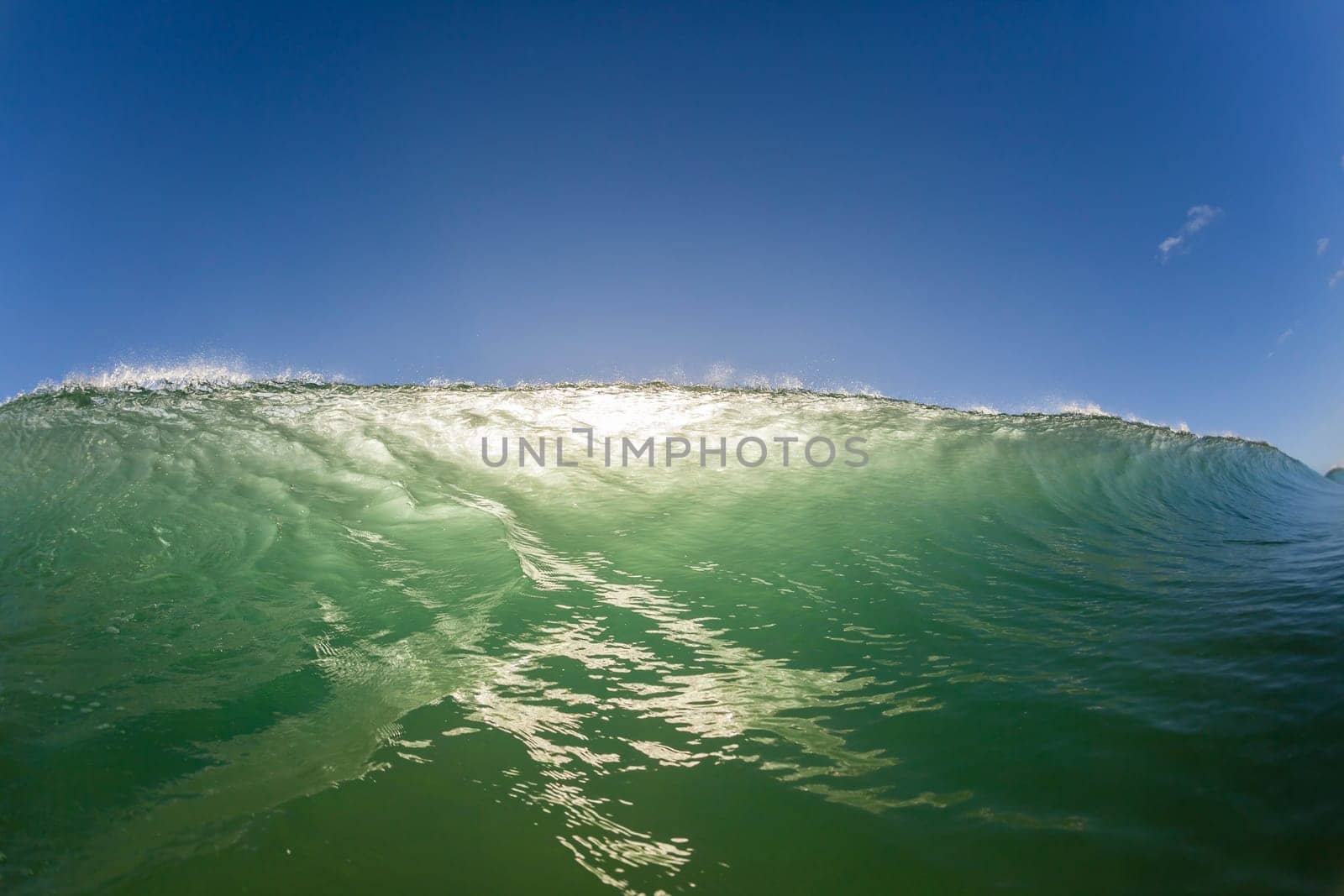Wave ocean swimming encounter wall of water crashing breaking beauty nature power back-light closeup photo. .