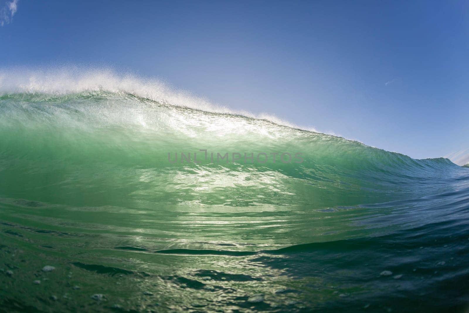 Wave ocean swimming encounter wall of water crashing breaking beauty nature power back-light closeup photo. .