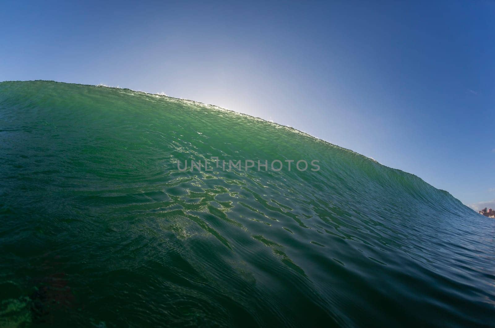 Wave ocean swimming encounter wall of water crashing breaking beauty nature power back-light closeup photo. .