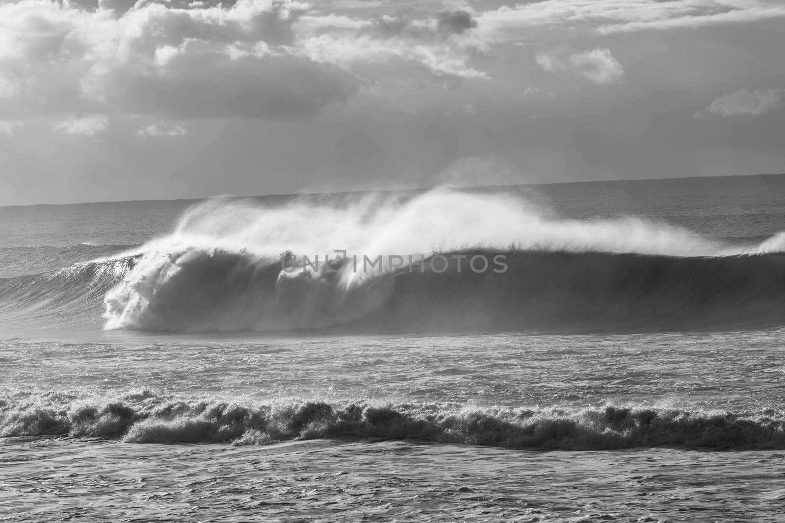 Ocean Waves crashing water power along beach rocky coastline from storm weather.