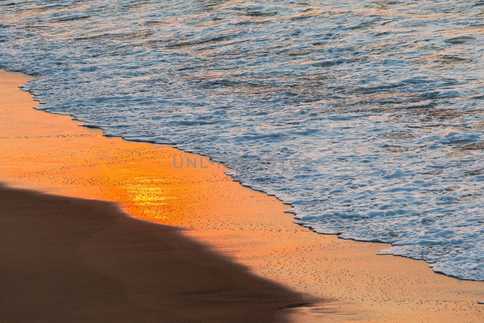 Beach sands waterline shoreline sunrise color mirror sunlight reflections of ocean water nature