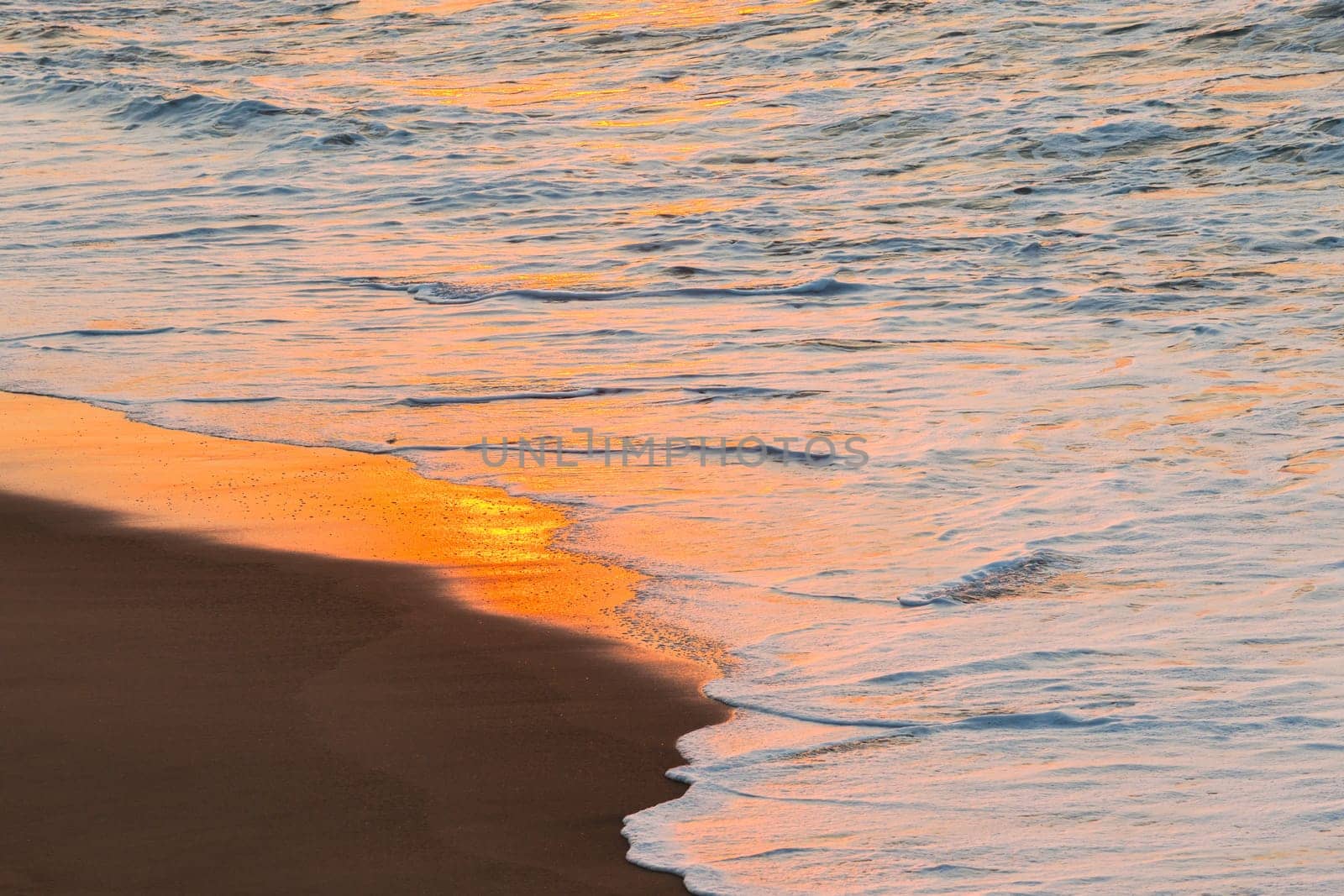 Beach sands waterline shoreline sunrise color mirror sunlight reflections of ocean water nature